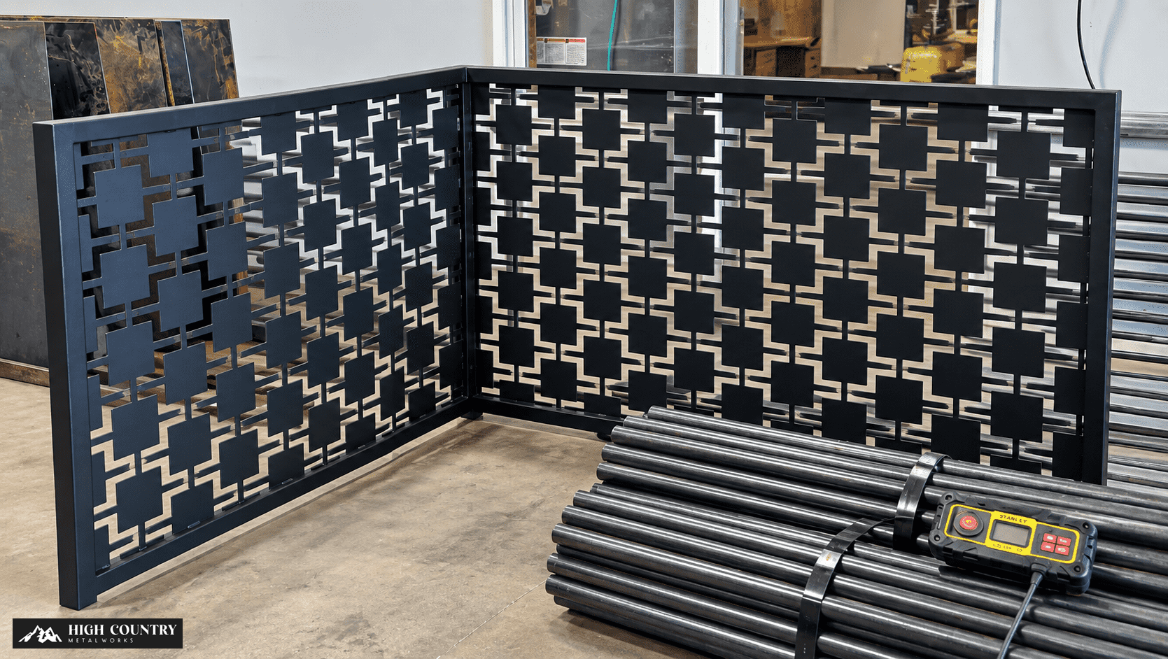 A decorative metal screen featuring an intricate black pattern designed by high country metal works A decorative metal screen featuring an intricate black pattern designed by high country metal works