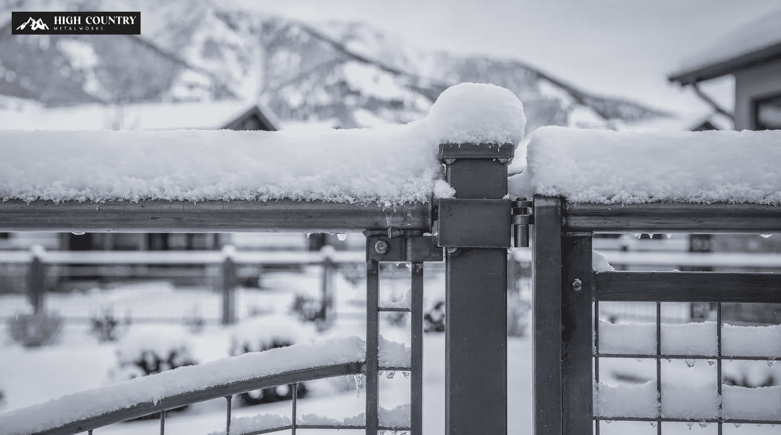 Black and white photo of a snow-covered metal fence, highlighting damage from snow load on railings and gates. Black and white photo of a snow-covered metal fence, highlighting damage from snow load on railings and gates.