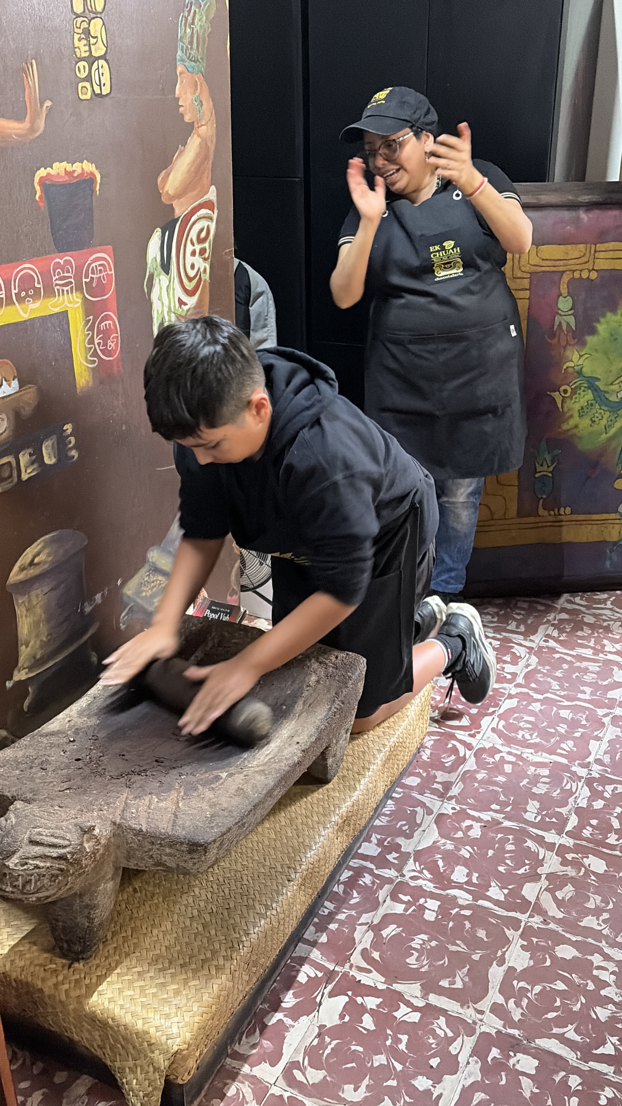 Grinding cacao on a traditional stone metate
