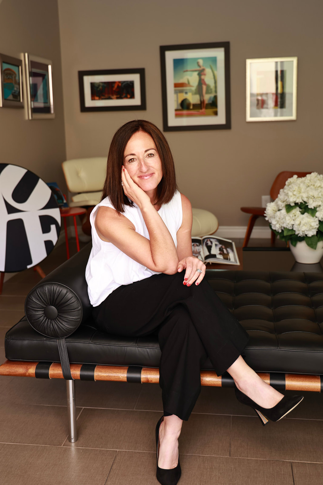 Anamarie Lopategui from Bideako sitting on a black chase lounger.