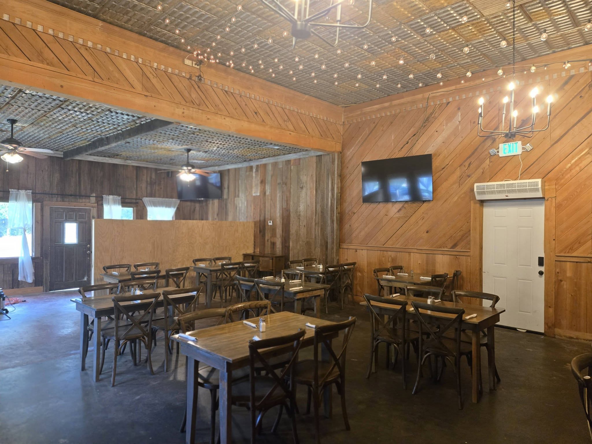 The Ranch dining room at Haifa's — tin ceiling, chandeliers and string lights
