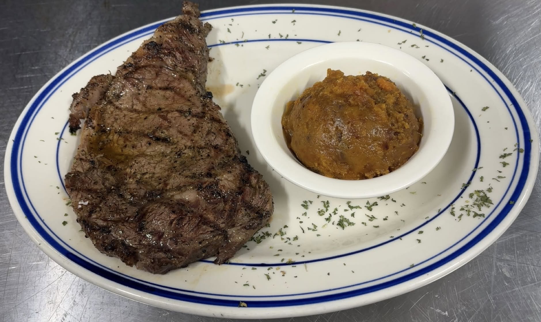 Hand-cut grilled ribeye steak with a side of candied sweet potato at Haifa's Magnolia Grill & Pub in Sumrall, MS
