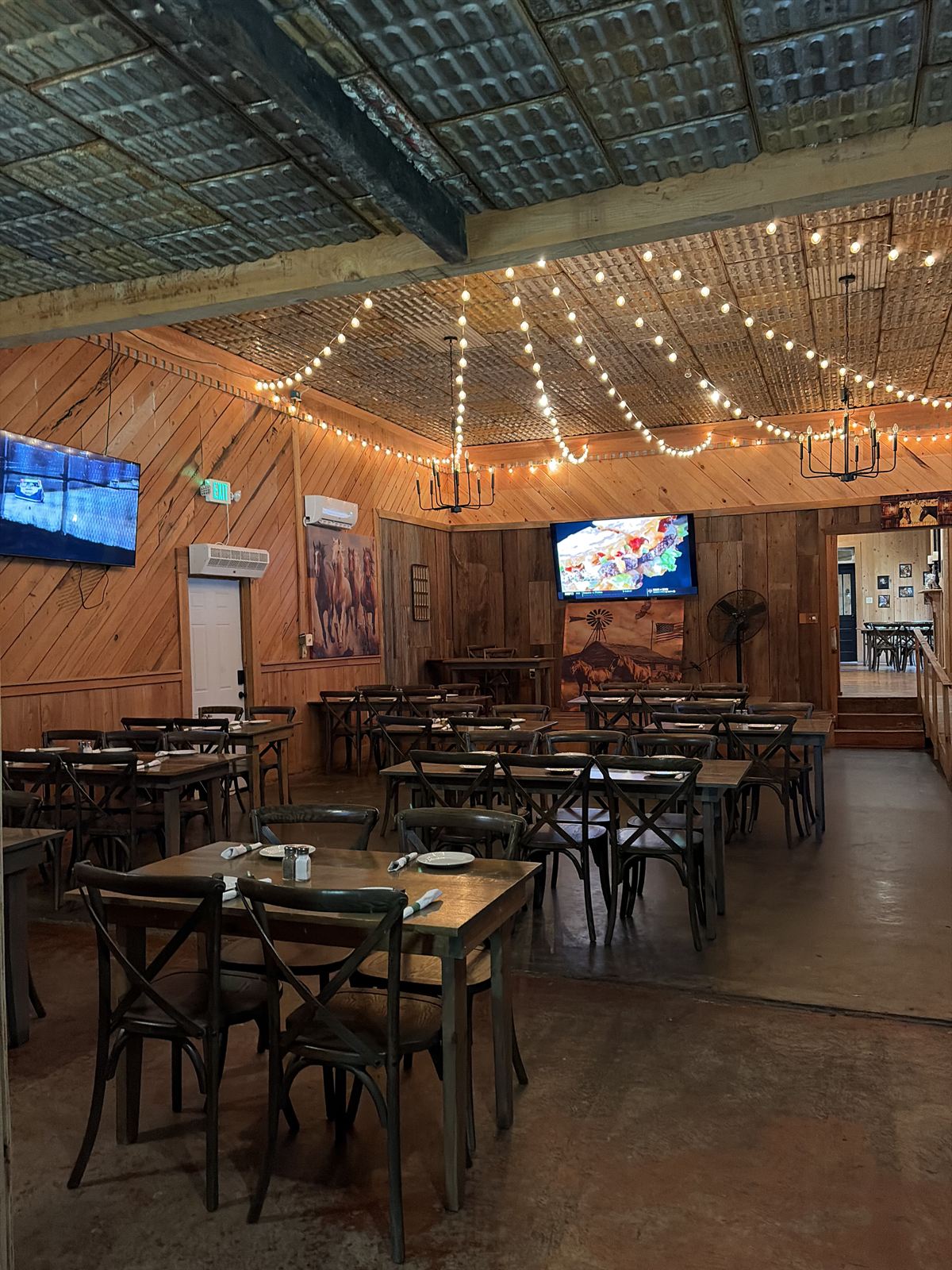 The Ranch dining room at Haifa's under string lights and a tin ceiling
