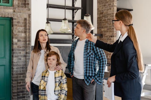 A family of three talking to a real estate agent