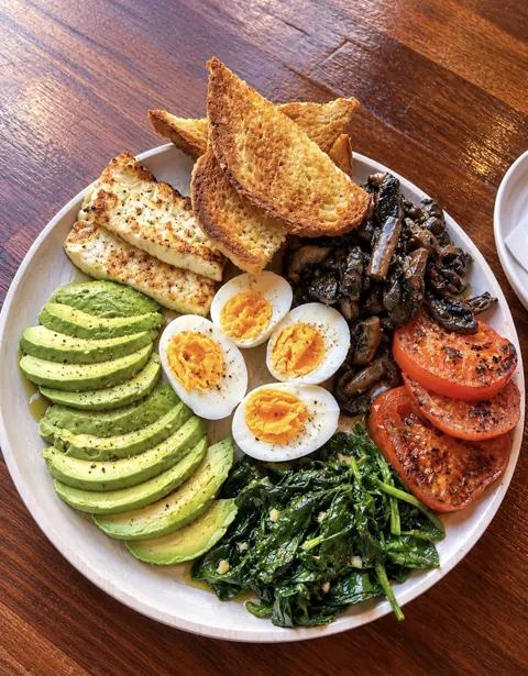 Build-your-own breakfast board with halloumi, eggs, avocado, mushrooms and tomato