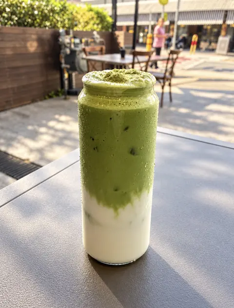 Coconut milk matcha foam served at an outdoor table