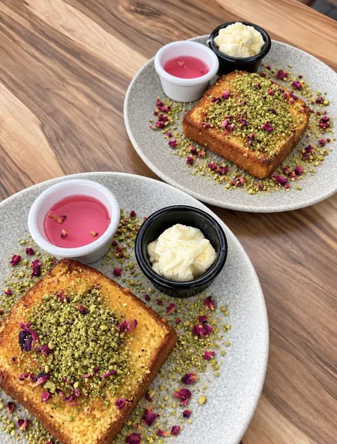 Knafeh French toast topped with pistachio and rose petals