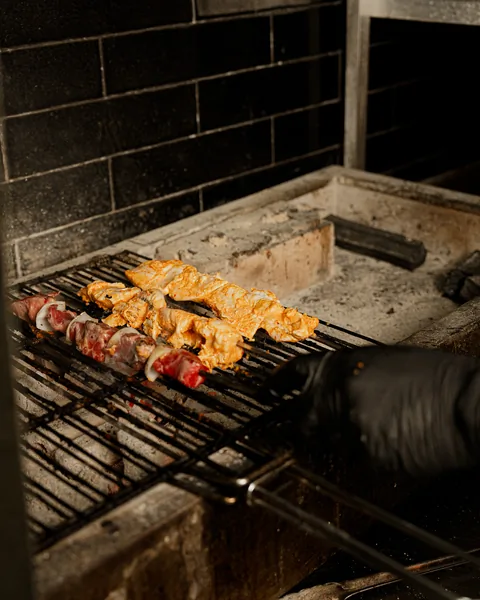 Skewers cooking over the charcoal grill