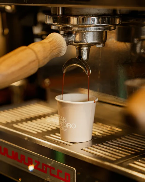 Espresso pouring from the machine into a cup