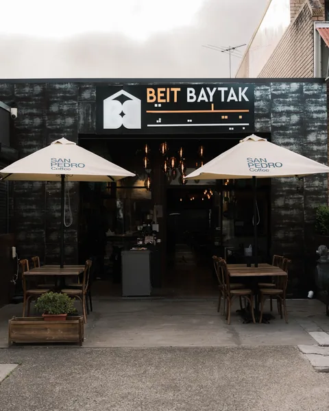 Beit Baytak shopfront with outdoor tables and umbrellas