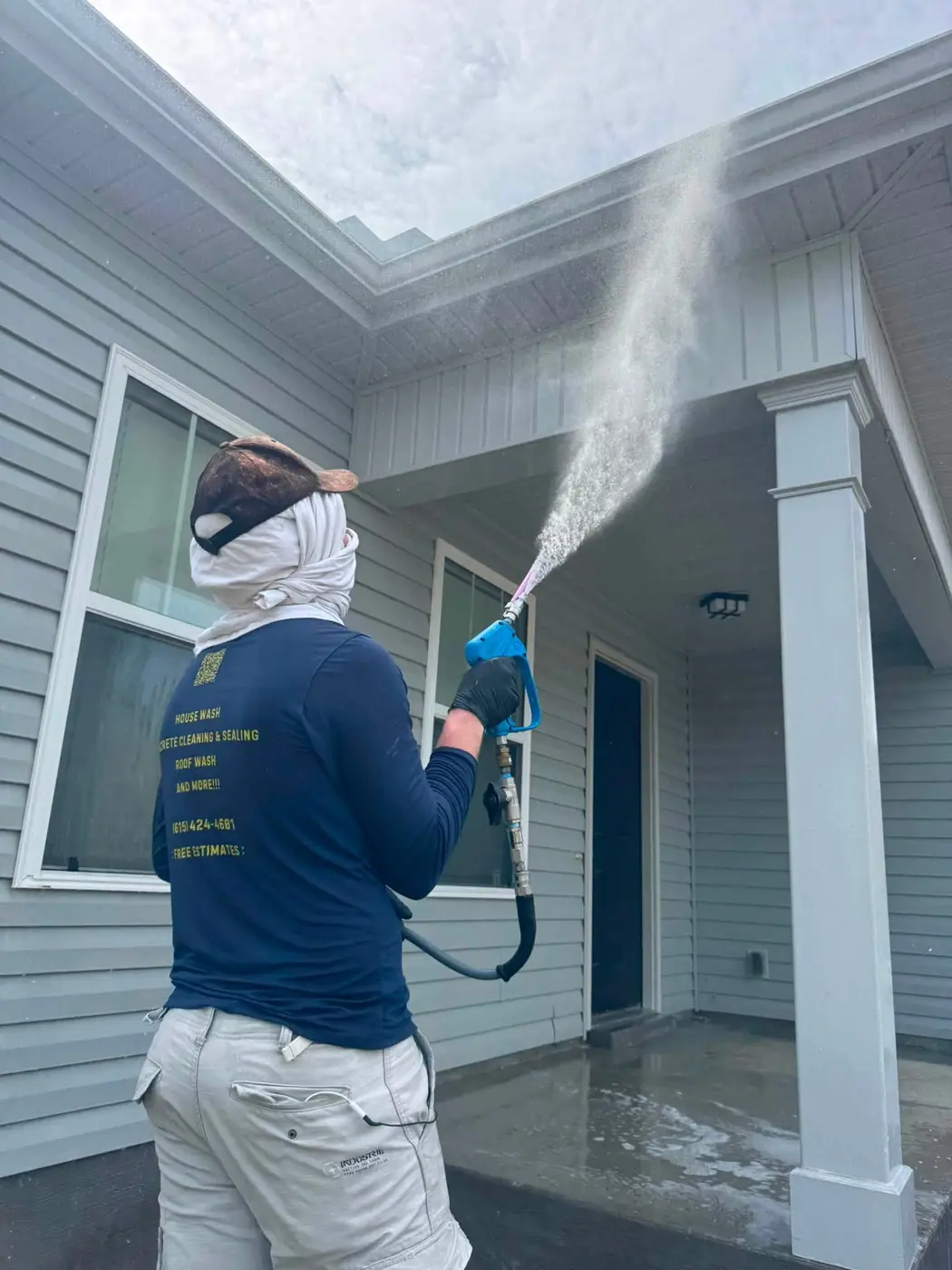Wash Wizard technician soft washing a house in Sumner County