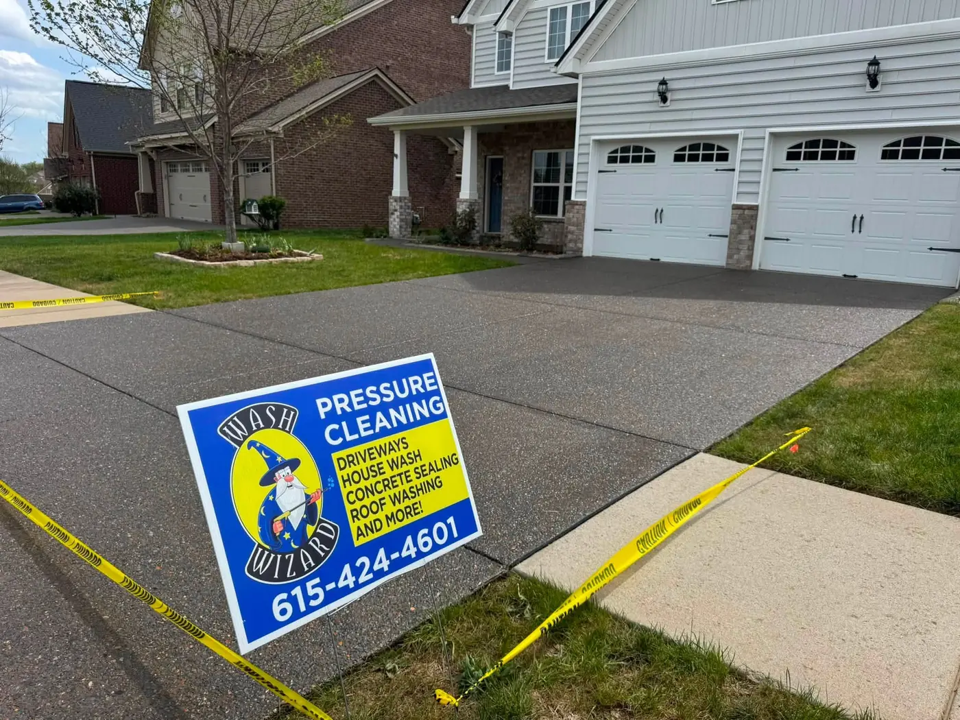 Sealed driveway with a Wash Wizard yard sign