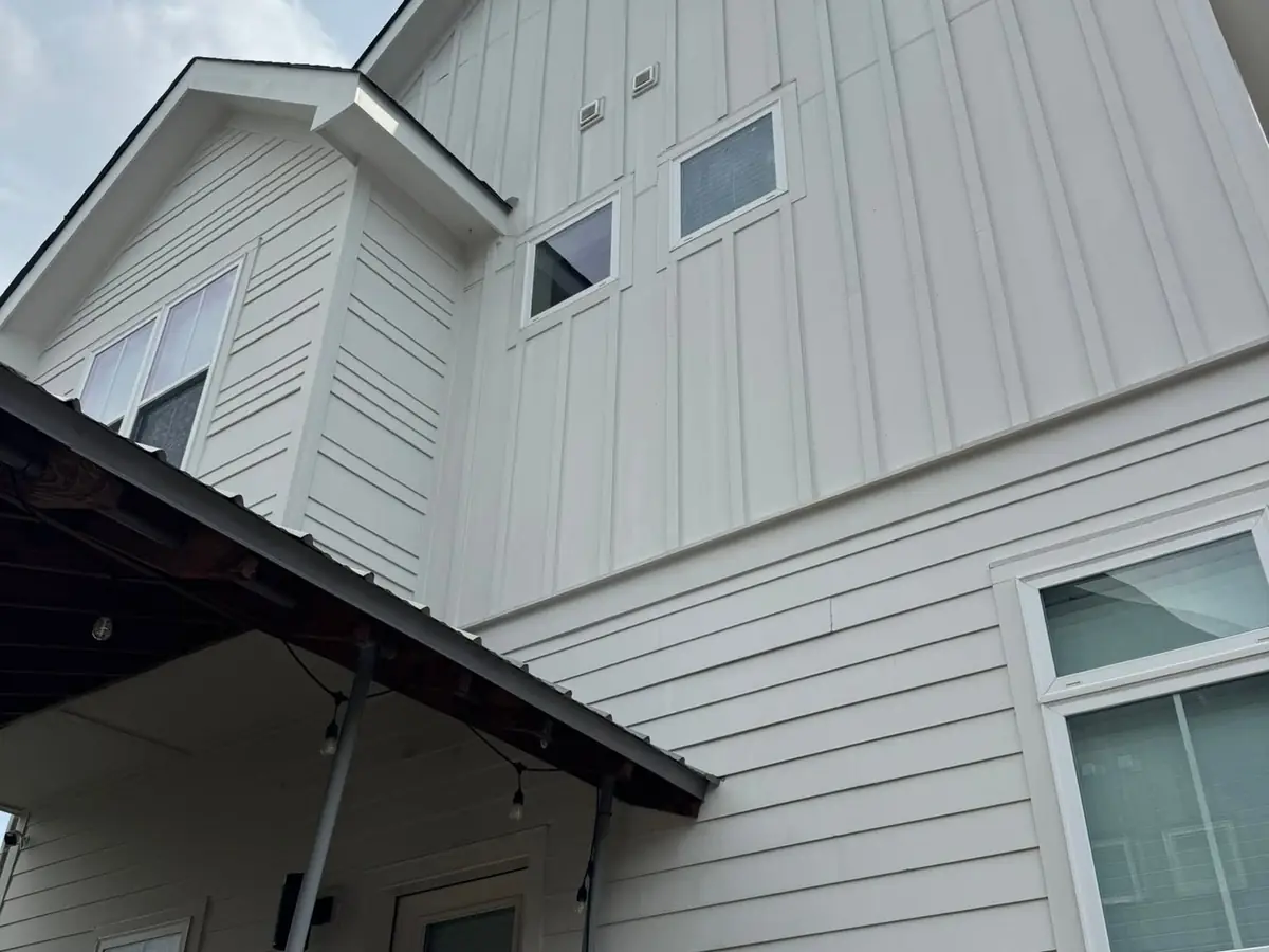 After: clean two-story siding after a Wash Wizard soft wash