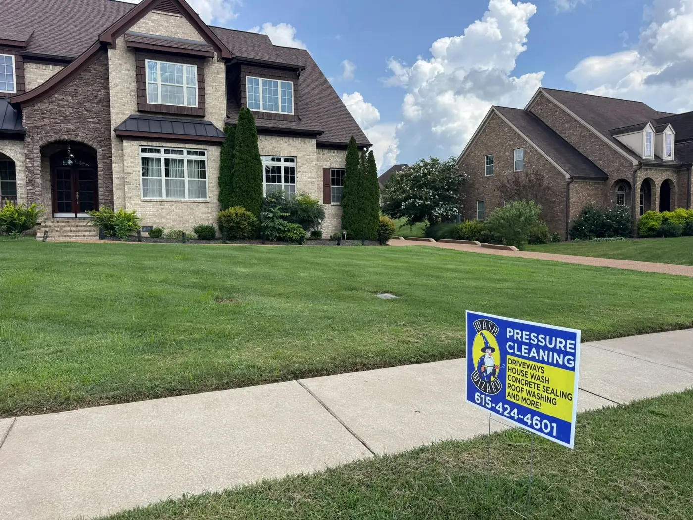 Wash Wizard yard sign in front of a freshly cleaned home