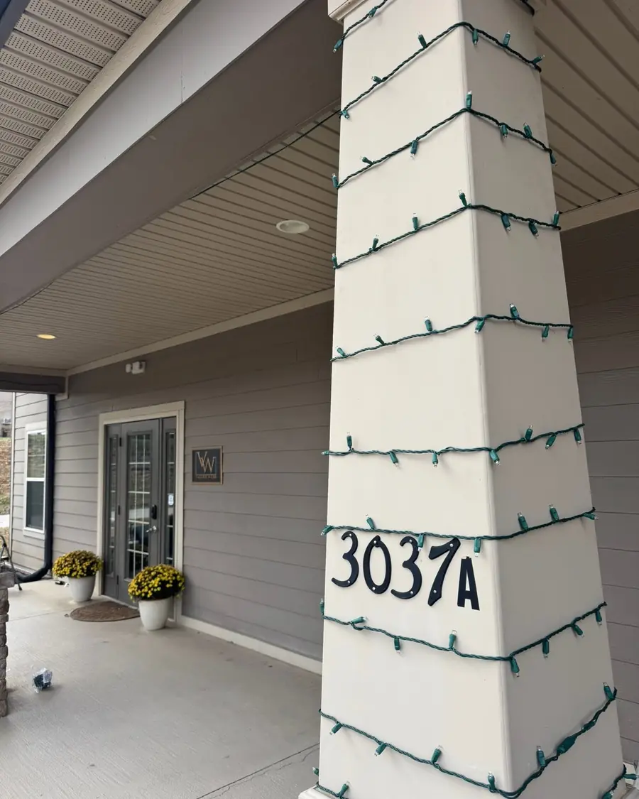 Porch column wrapped in Christmas lights
