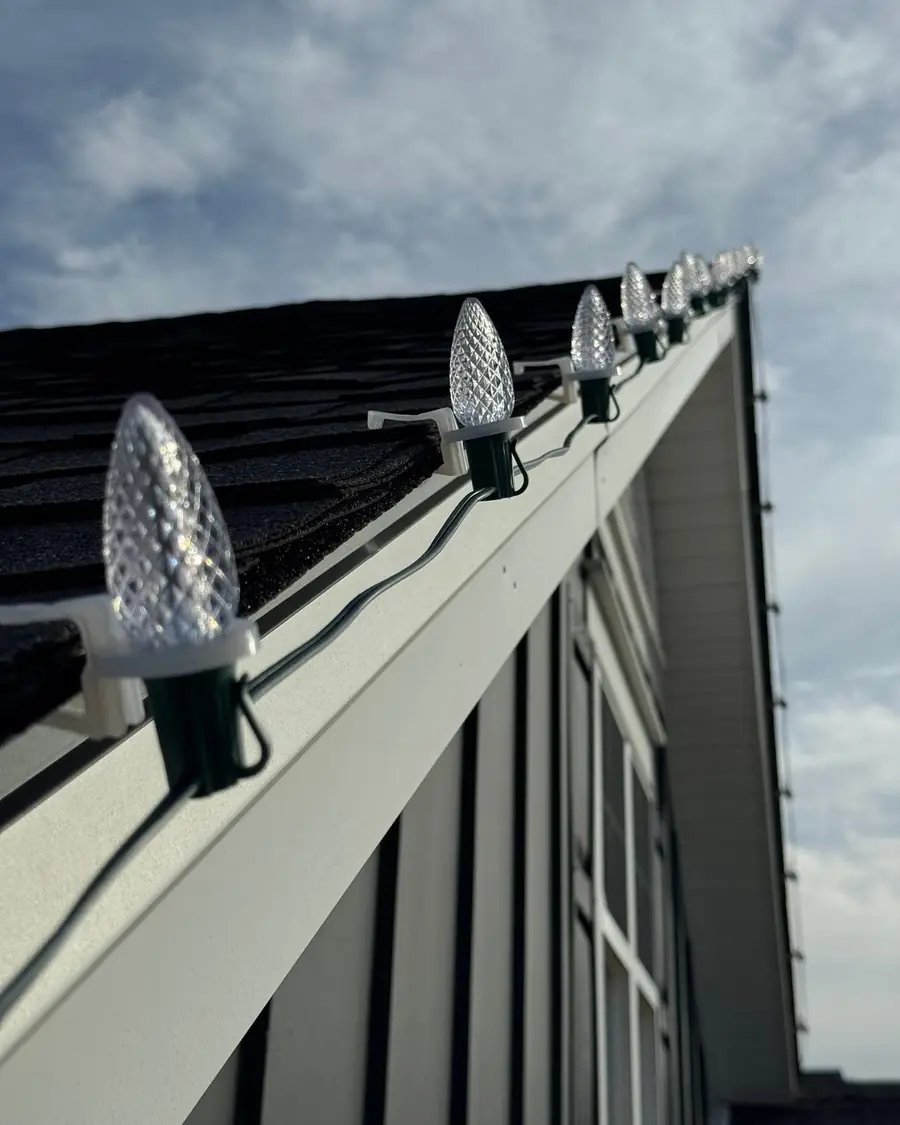 C9 Christmas bulbs on roof-safe clips along a gutter