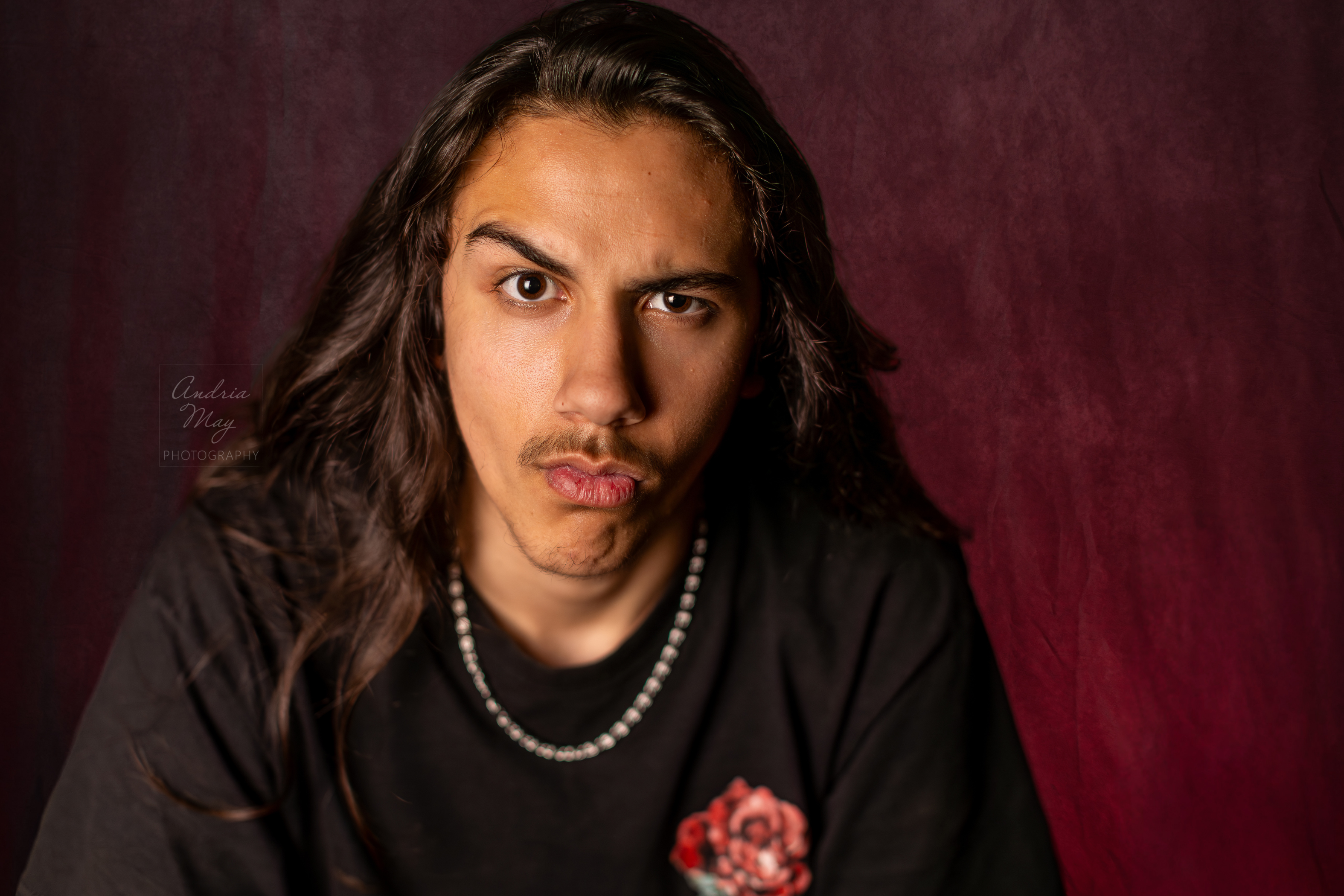 Indoor senior portrait sessions are a great option for high school seniors who want a creative, studio-inspired look. Professional lighting and simple backgrounds keep the focus on personality and expression.
