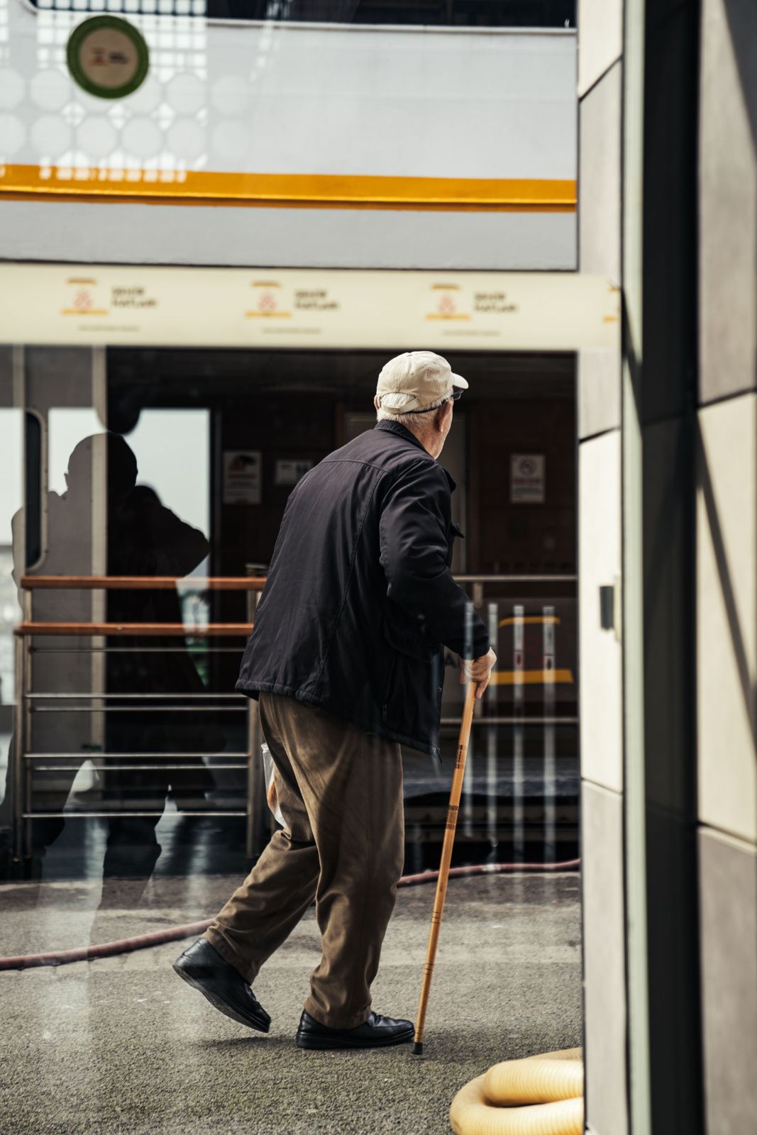 An older man walking with a cane