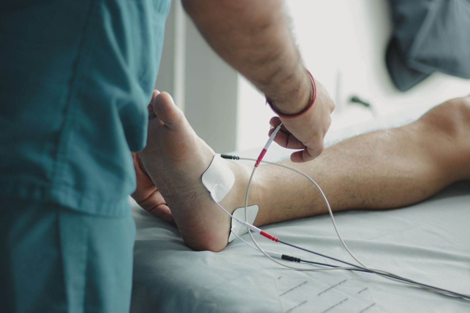 A clinician testing a patient's foot