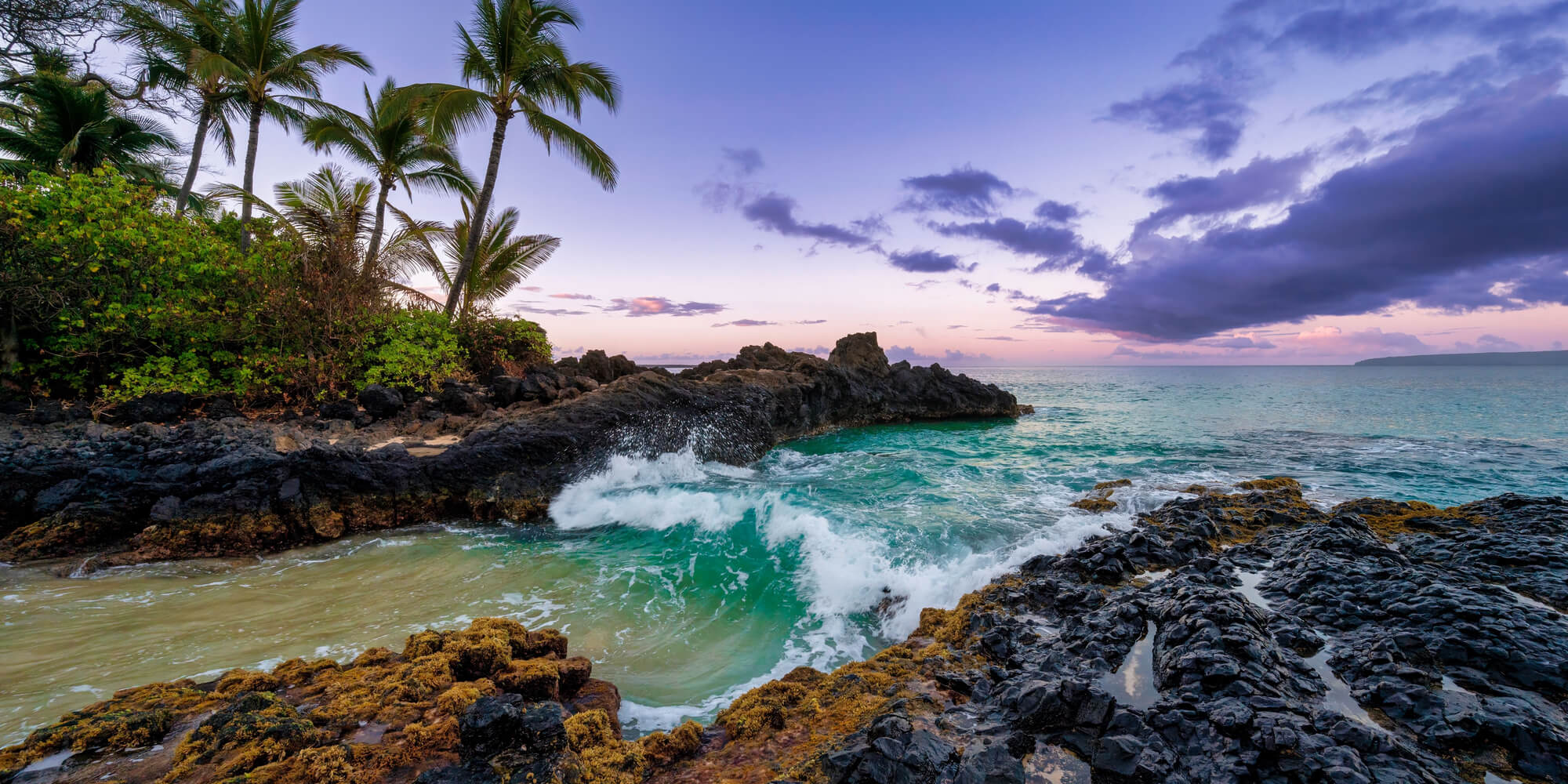 Aerial view of Maui's stunning coastline with turquoise water and lush green hills