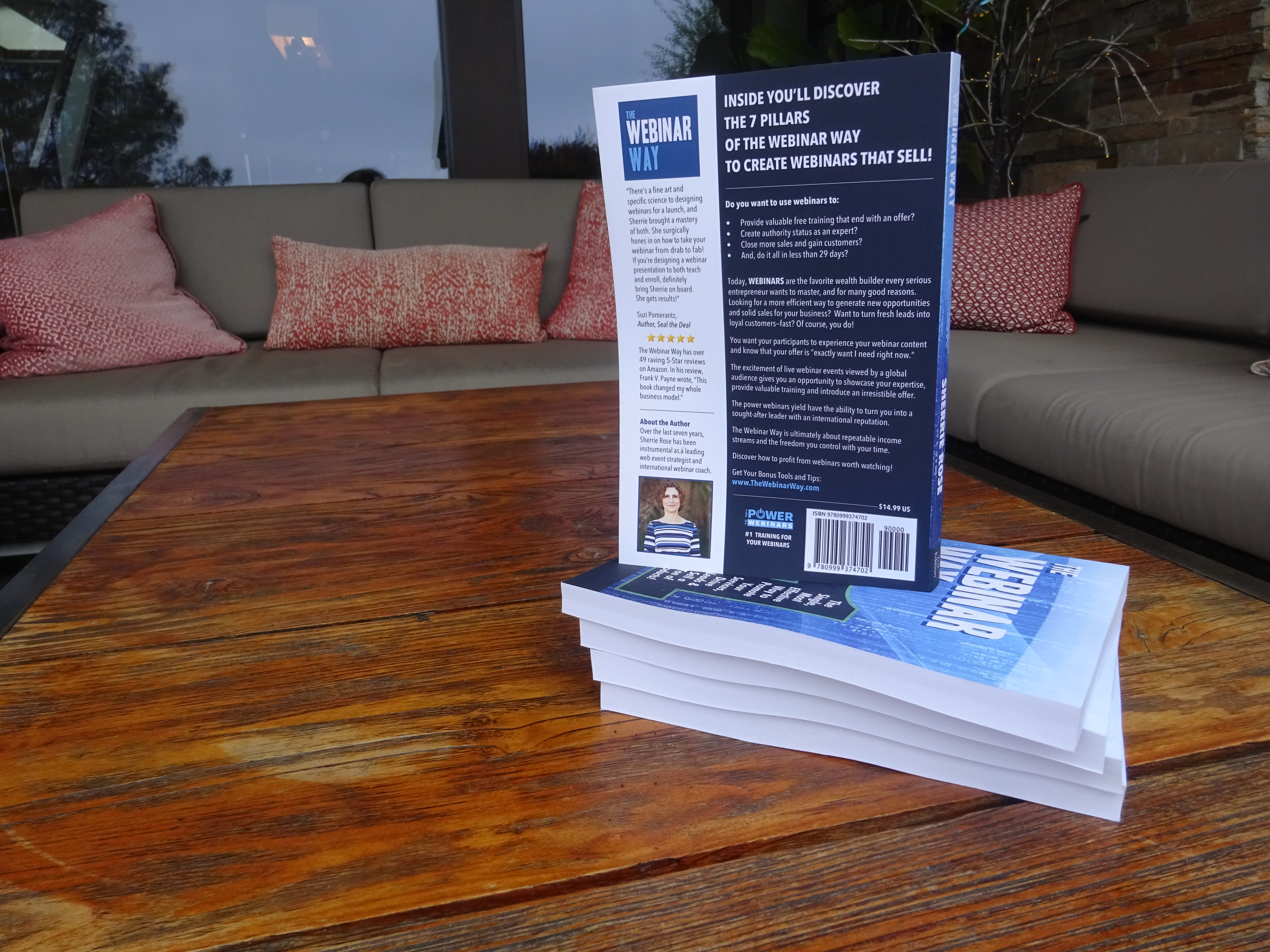 Photo of book, The Webinar Way by Sherrie Rose, author, back cover on a stack of the books