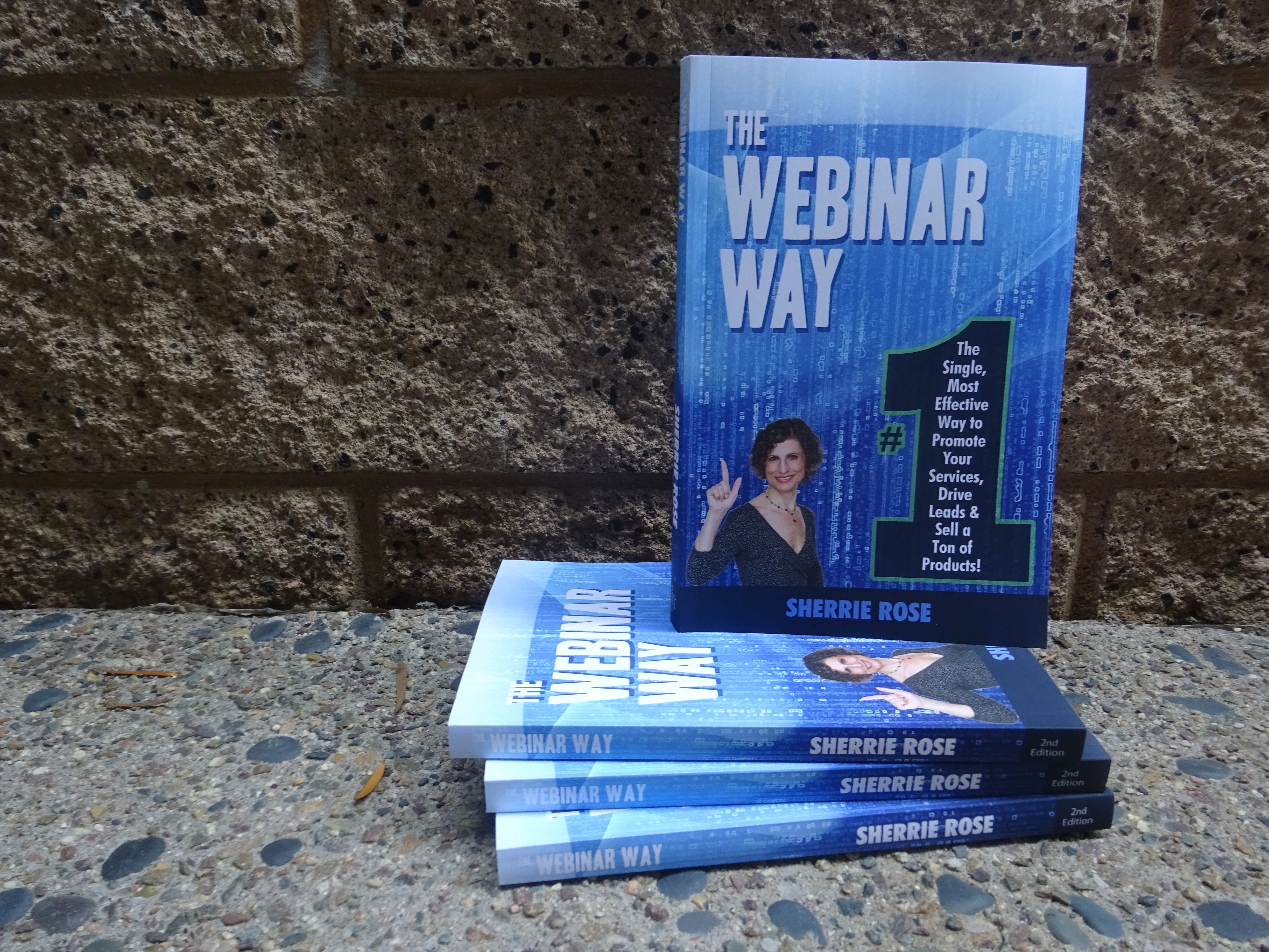Photo of book, The Webinar Way by Sherrie Rose, author, copies stacked