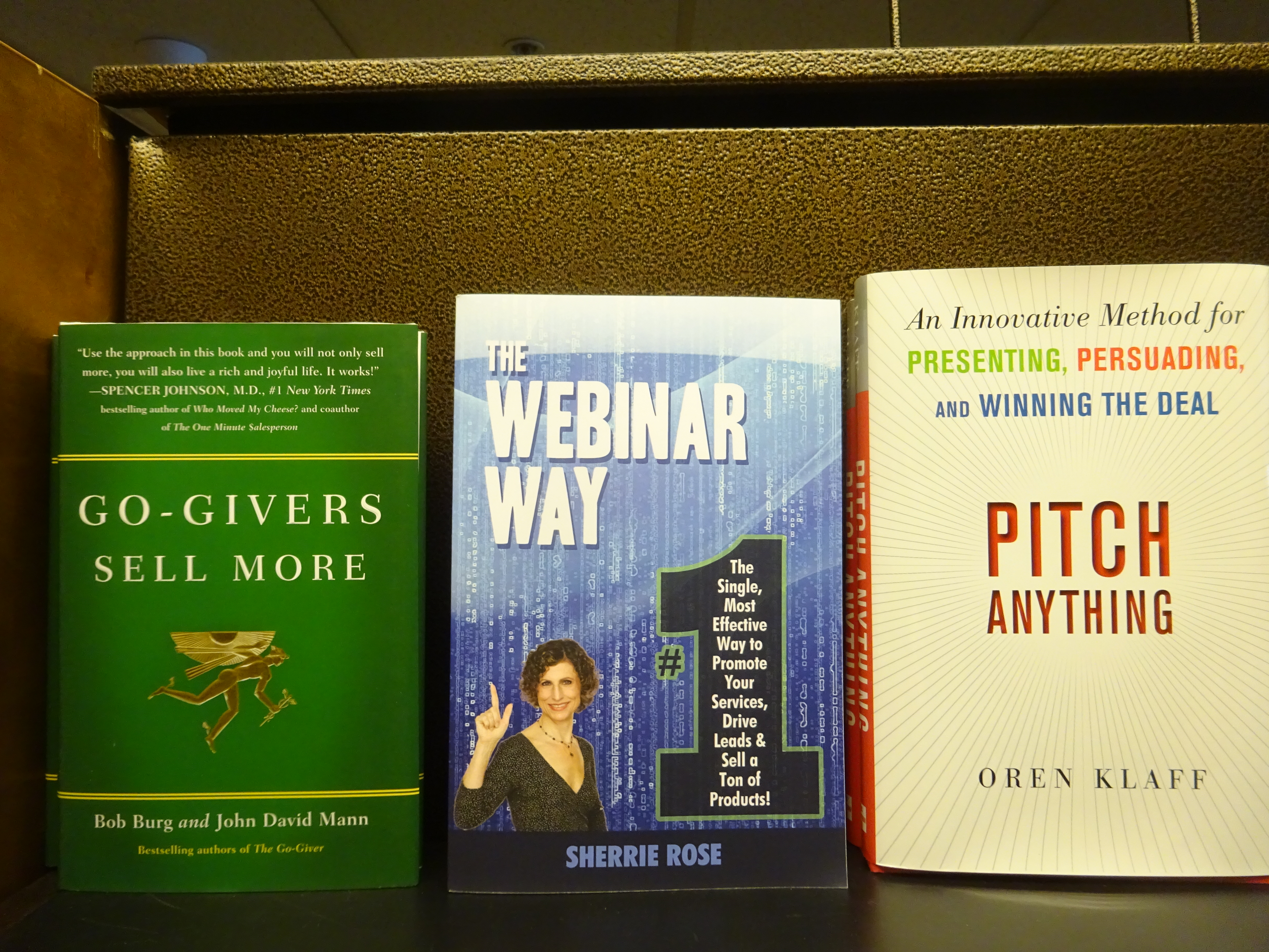 Photo of book, The Webinar Way by Sherrie Rose, author, on a bookshelf with other books
