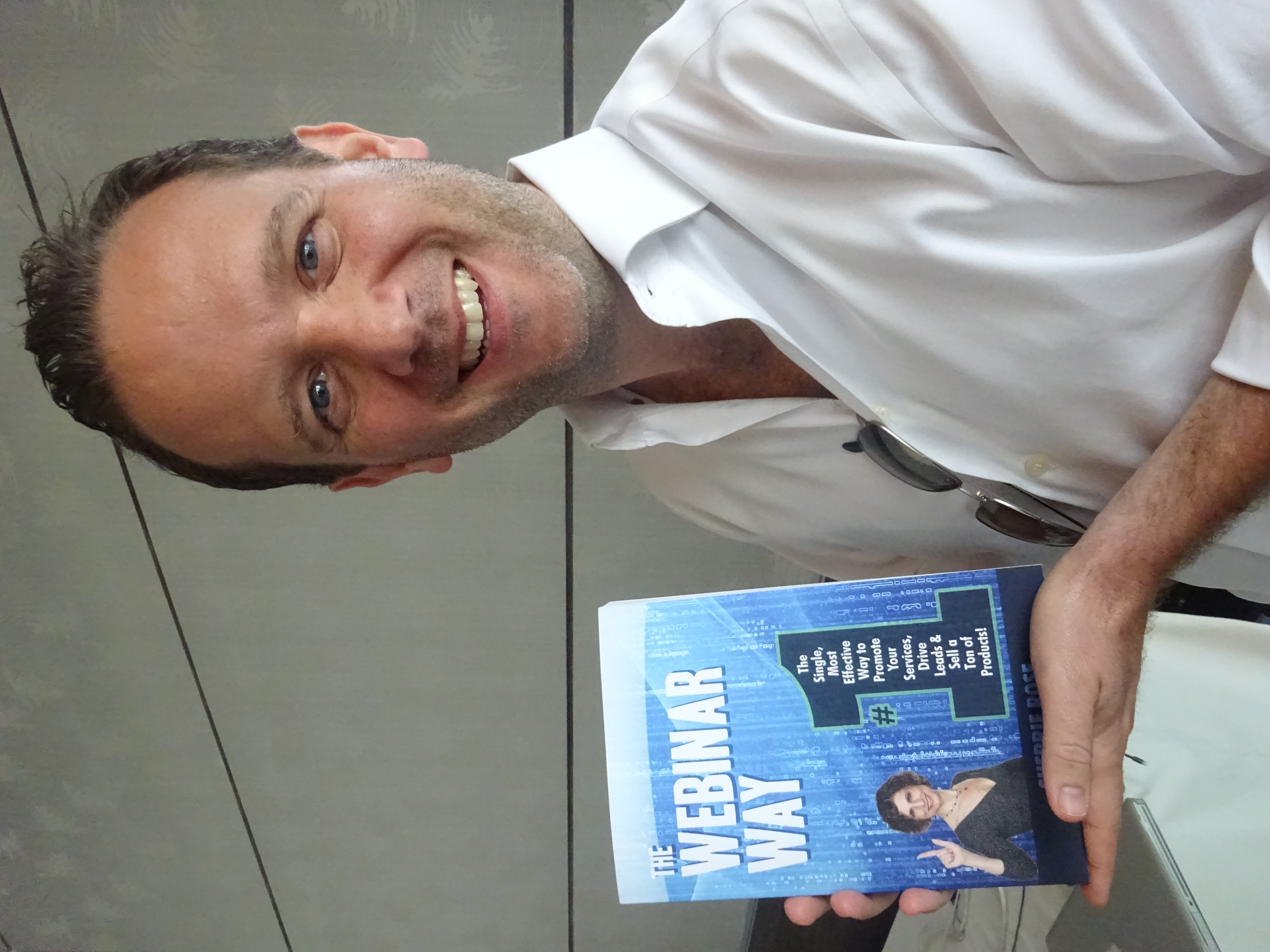 Photo of book, The Webinar Way by Sherrie Rose, author, in a portrait