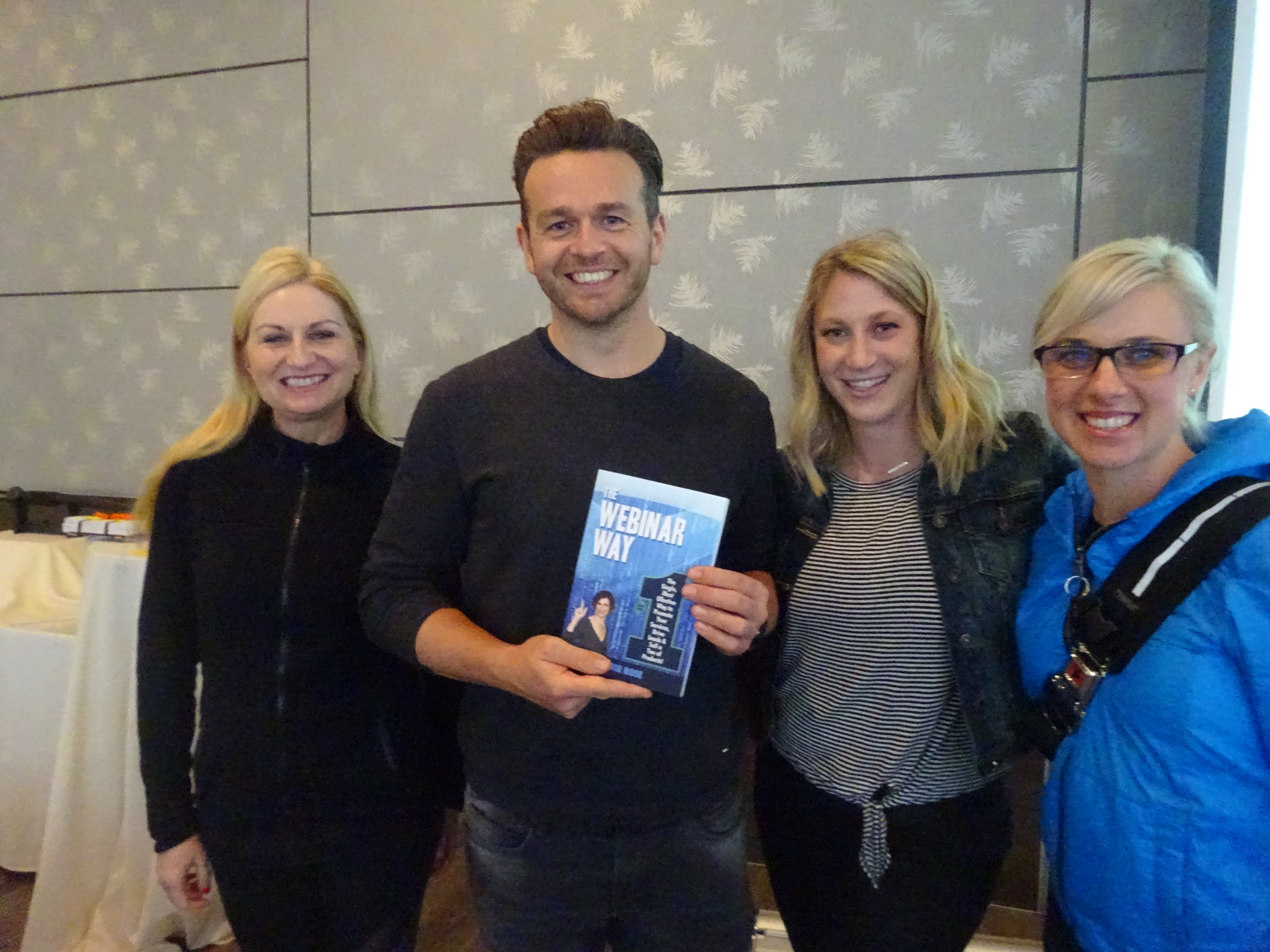 Photo of book, The Webinar Way by Sherrie Rose, author, with people