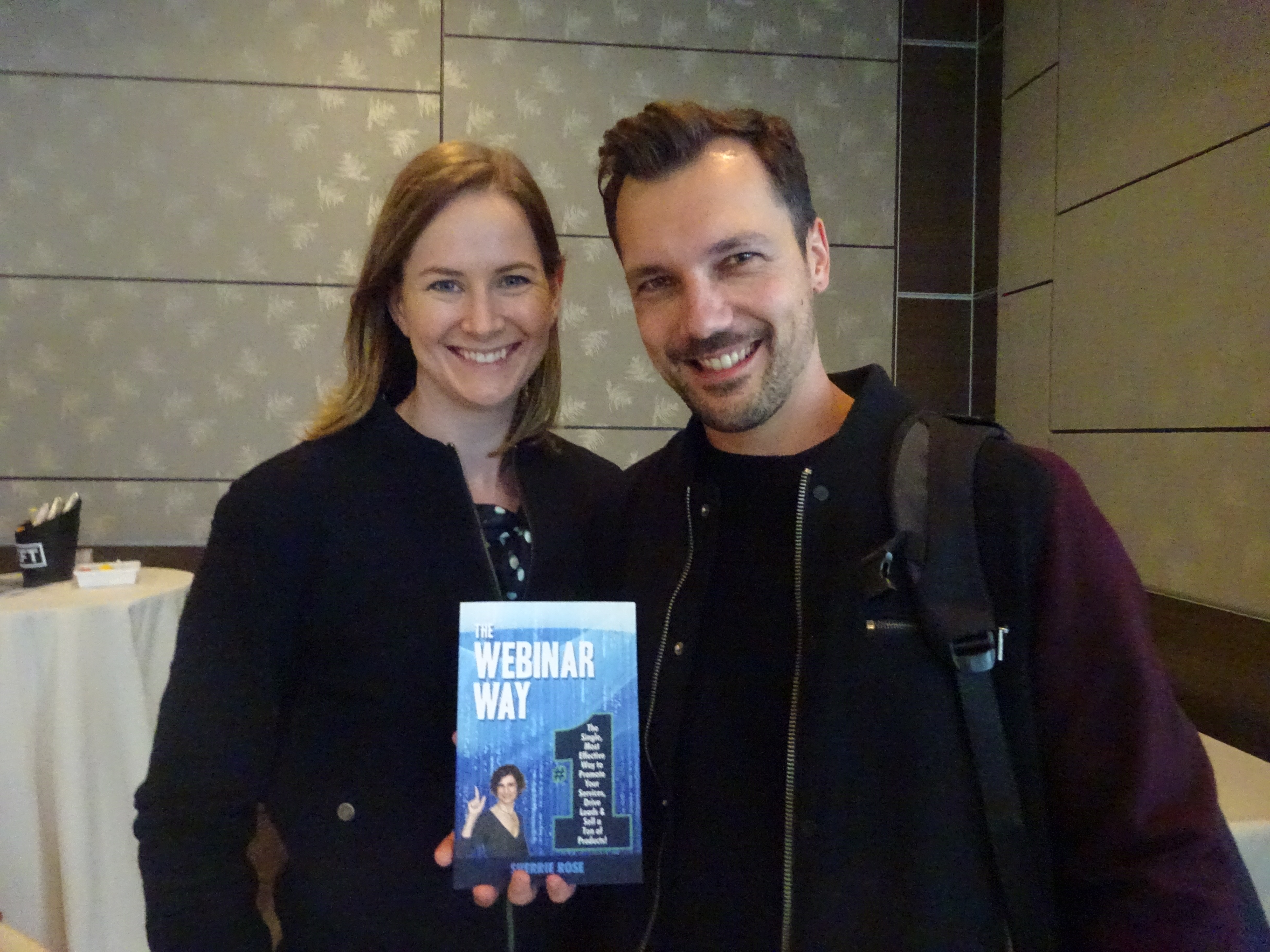 Photo of book, The Webinar Way by Sherrie Rose, author, with people
