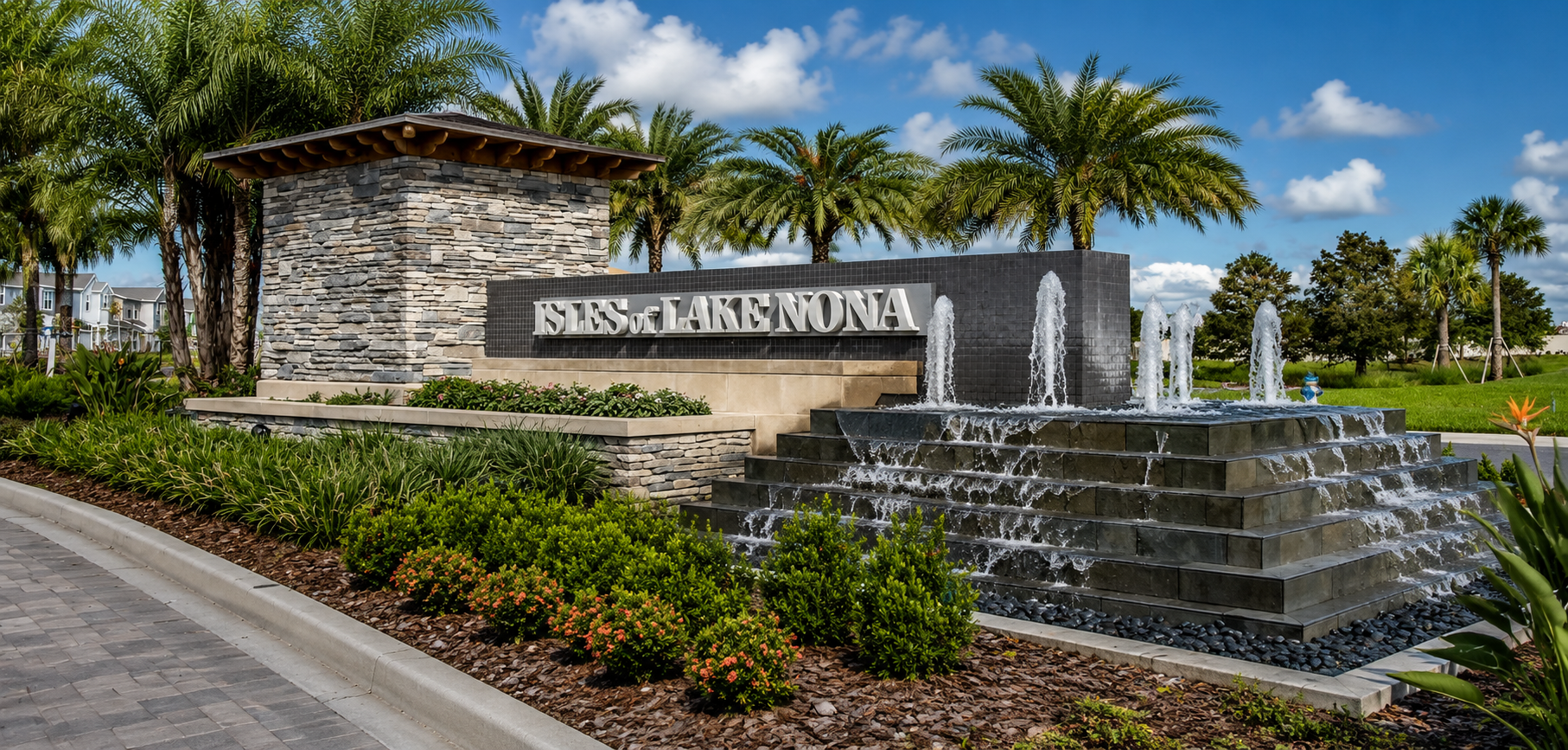 Isles of Lake Nona entrance in Orlando, Florida, featuring the community monument sign, tiered fountain, palm trees, and manicured landscaping in a luxury Lake Nona neighborhood.