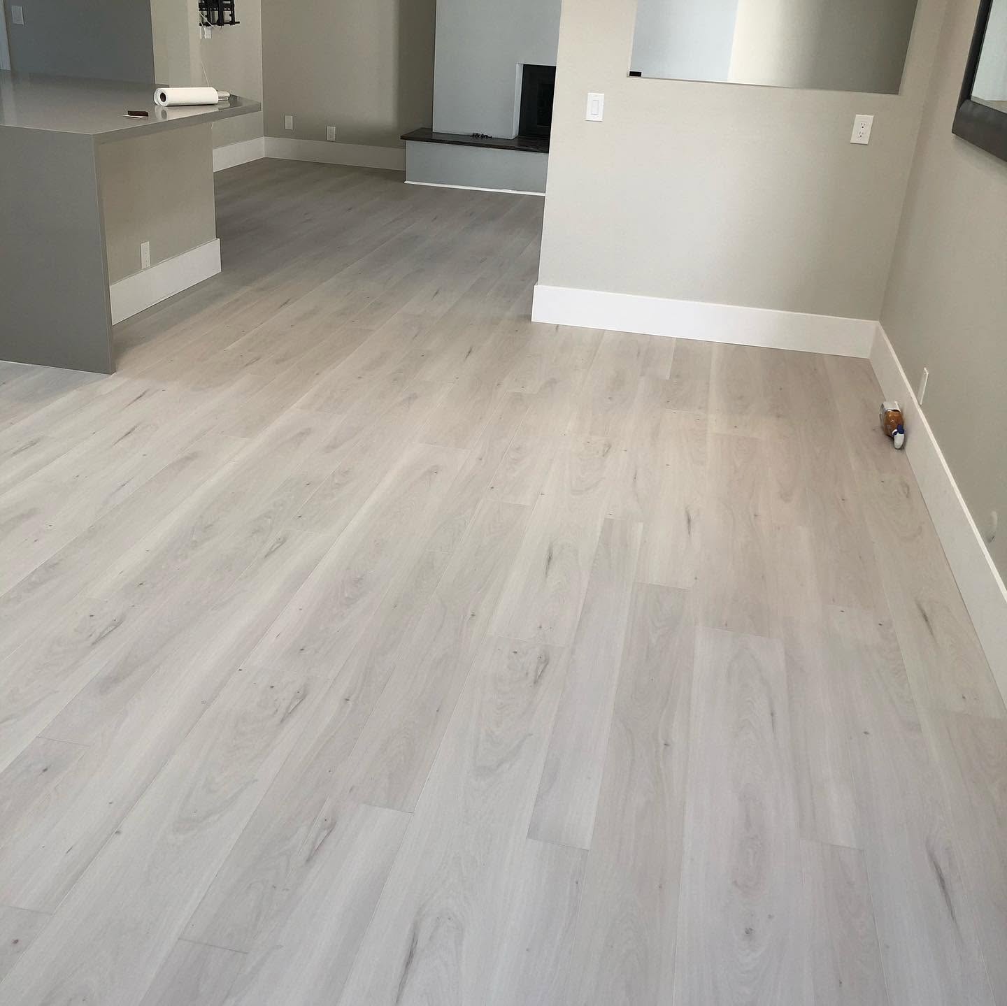 Gray luxury vinyl plank flooring installed in an open living area