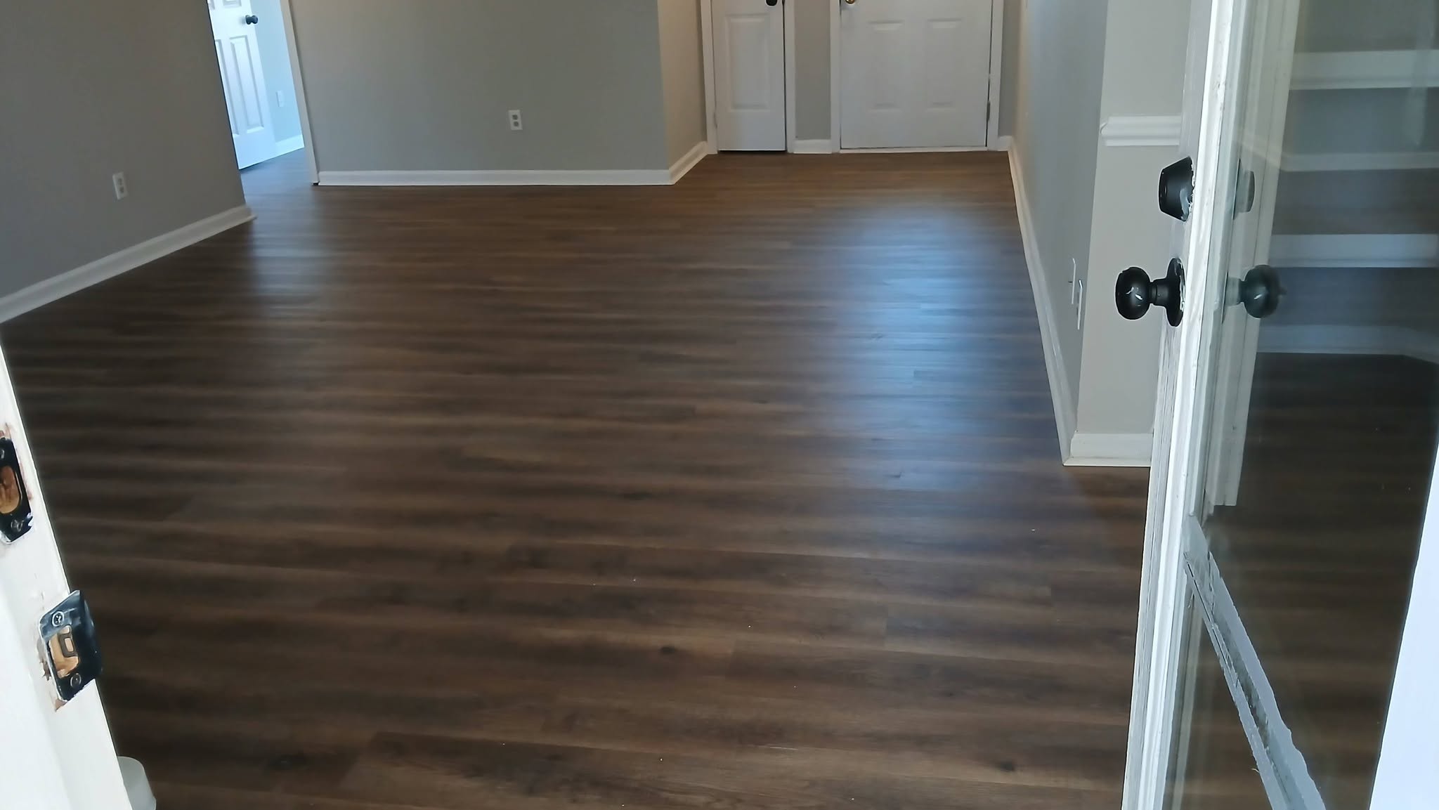 New dark wood-tone luxury vinyl plank (LVP) floor in a mobile home living area