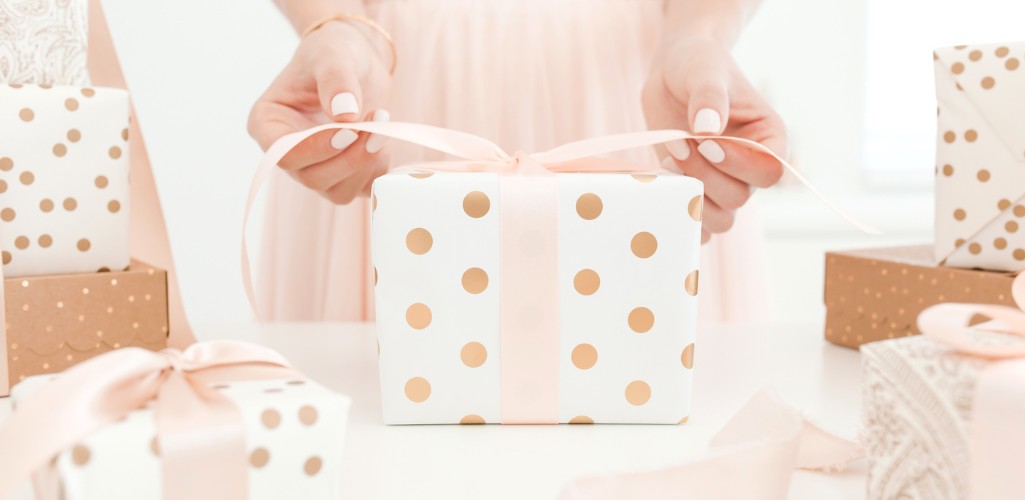 A woman wrapping a present. Planning for Christmas? Things to keep in mind