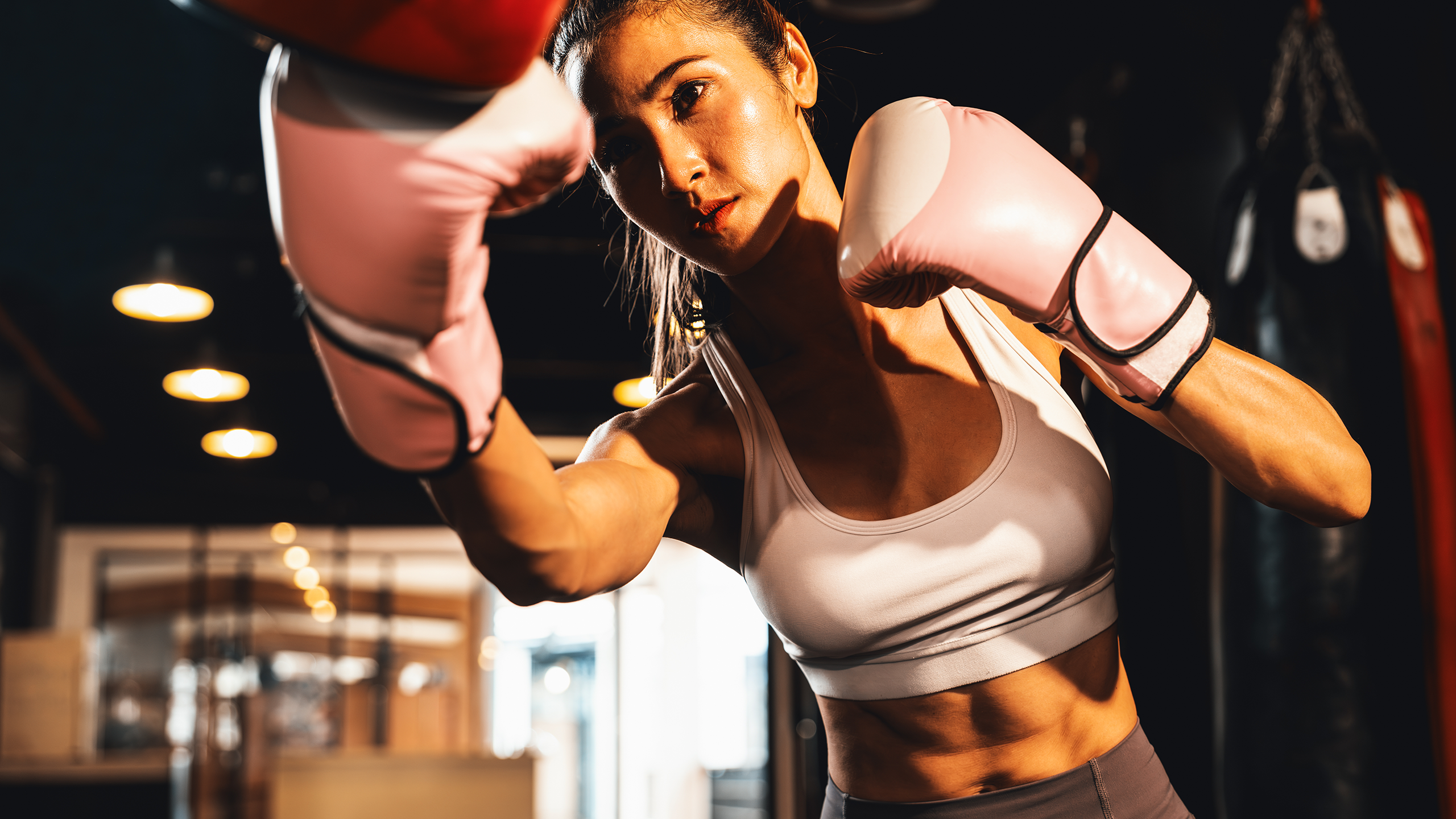 Beginner executing proper punches and elbow strikes during a Muay Thai training session