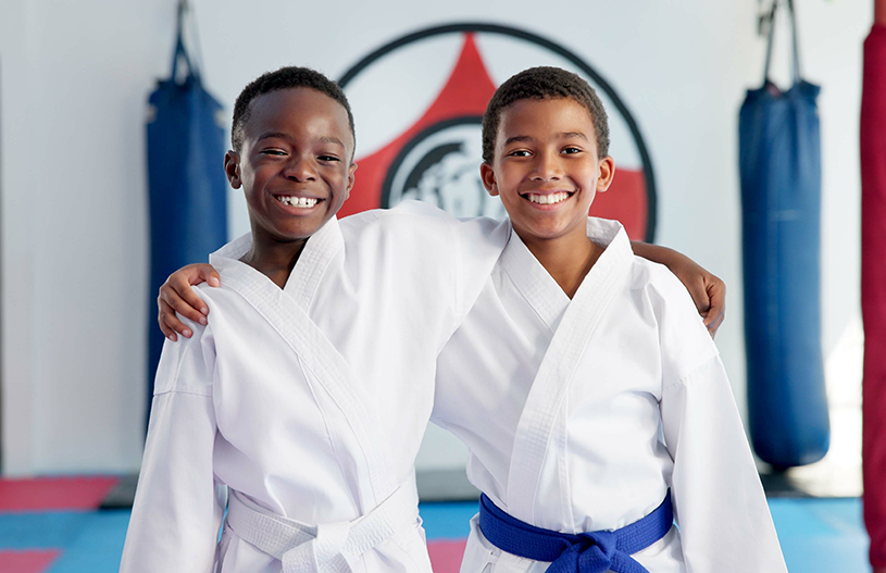 Two young boys smiling after martial arts class Two young boys smiling after martial arts class