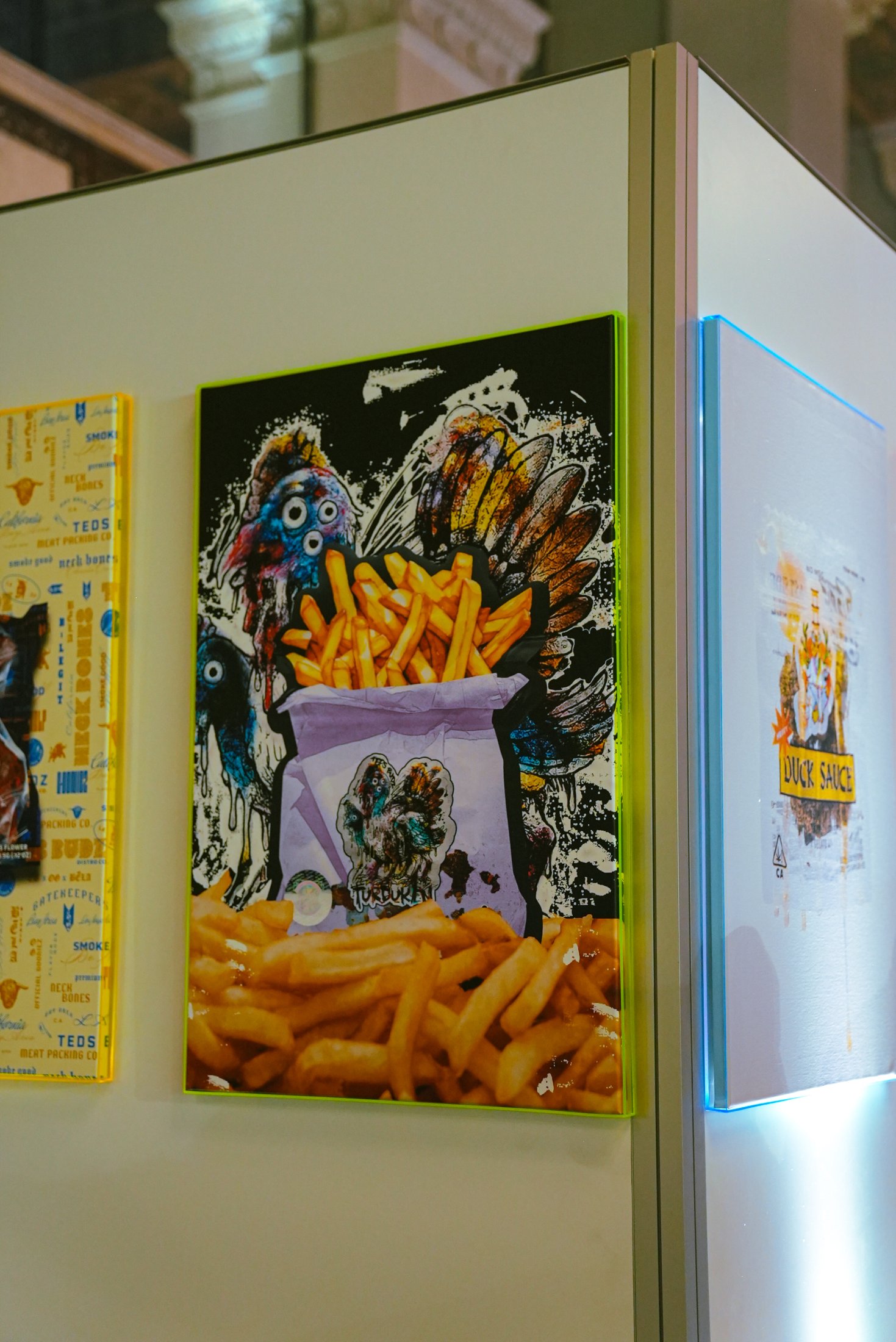 Neon-framed art wall inside the TED FEST retail build
