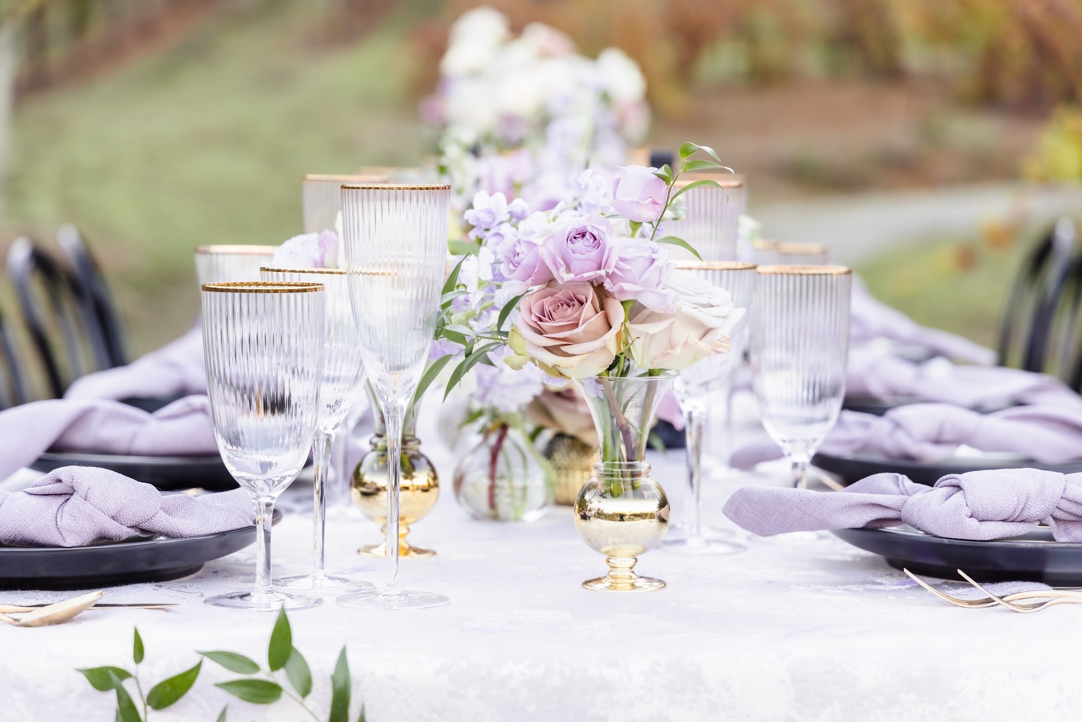 Ribbed glassware and lavender napkins at a Napa place setting