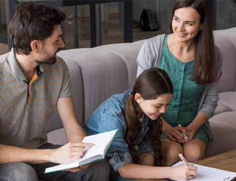 A family learning together on the couch