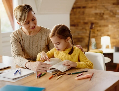 A mother and daughter reading together at home