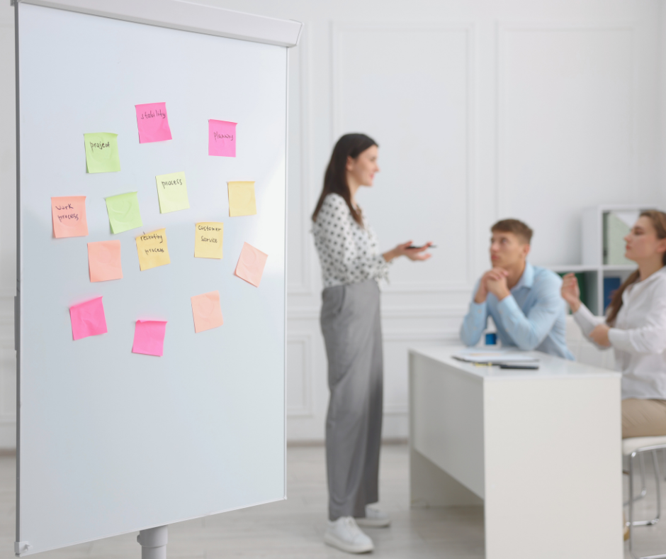 A behind-the-scenes shot of a founder reviewing notes or mapping out a process on a whiteboard A behind-the-scenes shot of a founder reviewing notes or mapping out a process on a whiteboard