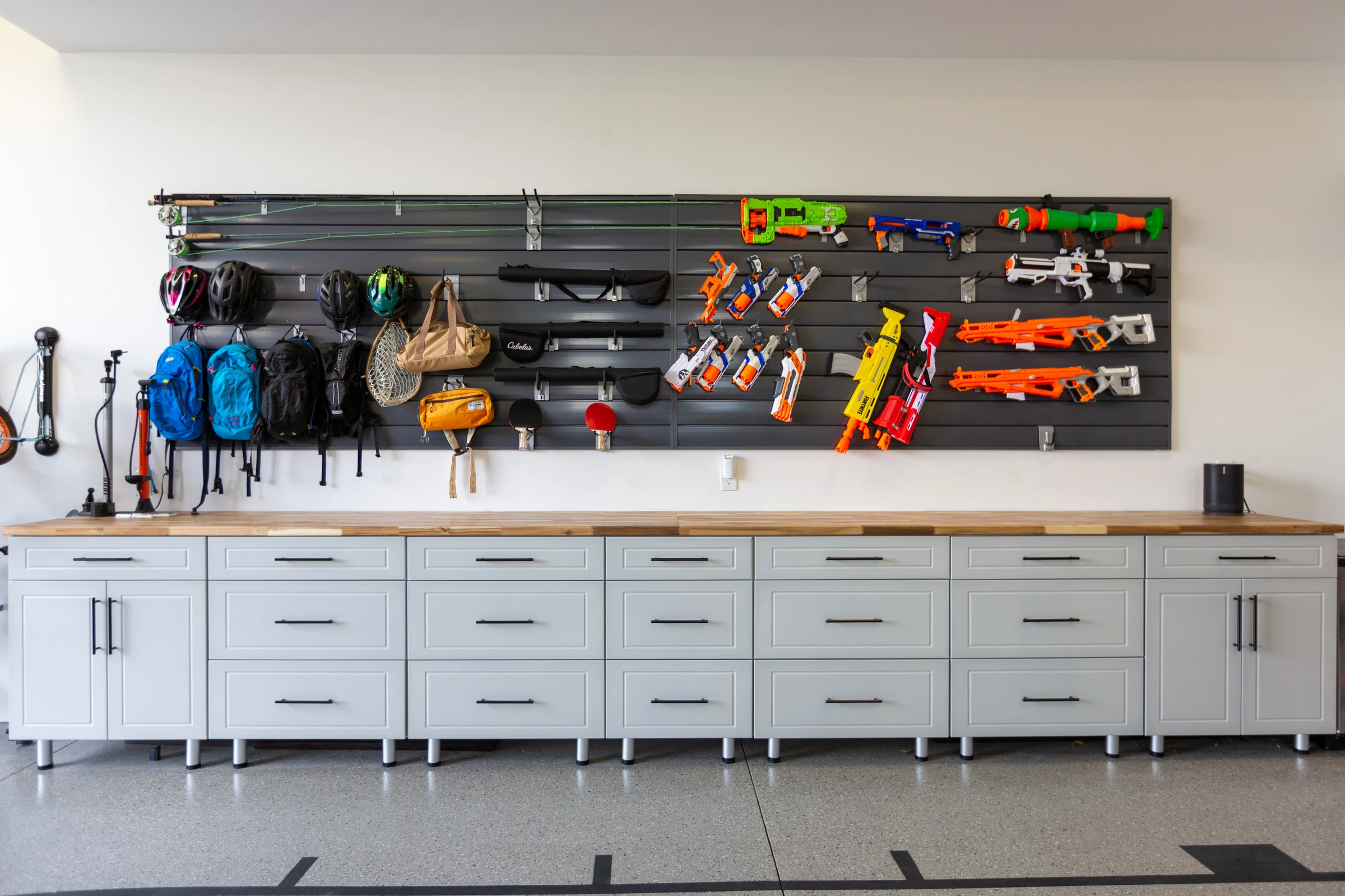 Garage slatwall organization system with hooks and custom workbench installed by Garage Titan in Boise, Idaho