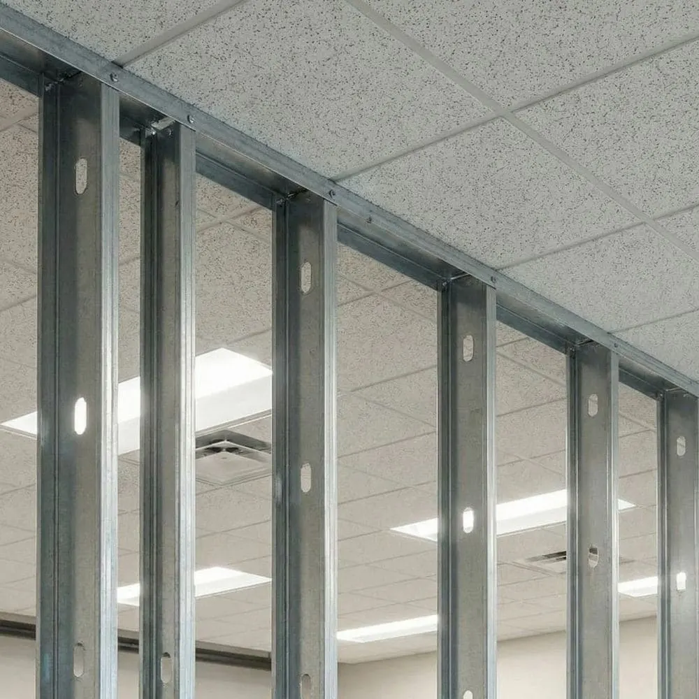 Steel track fastened to the ceiling holding studs in place