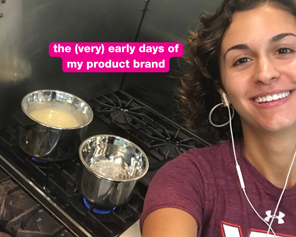 Gabi working at a standing desk while her twin toddlers play in the living room