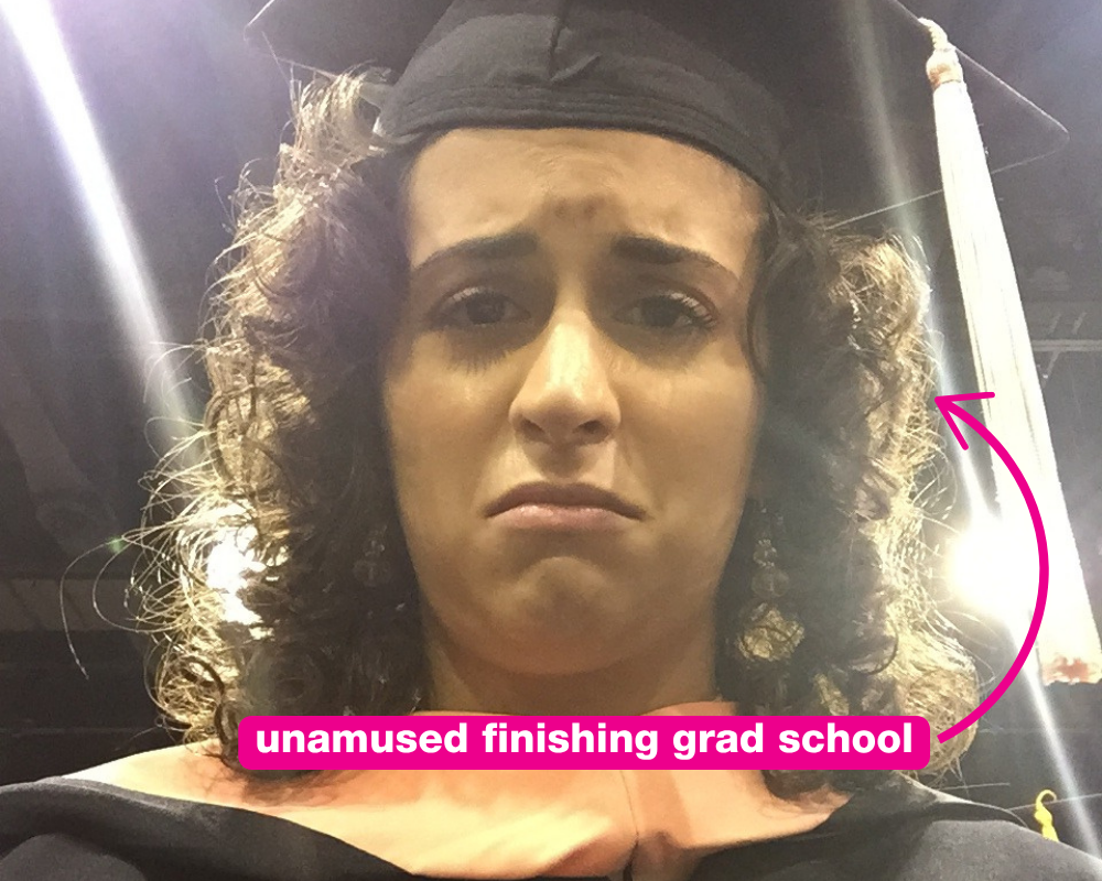 Gabi in grad school regalia looking exhausted — 'sad grad school Gabi'