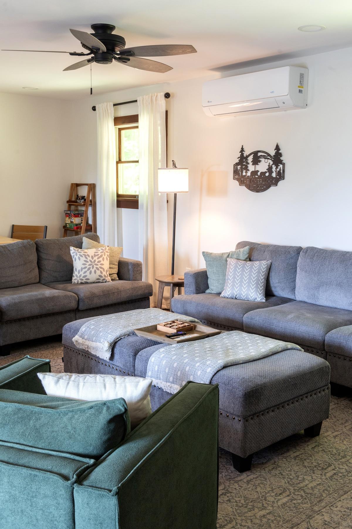 Find a spot on the sectional and stay there — the whole group fits, the room stays cool, and the fireplace is right there when you need it.