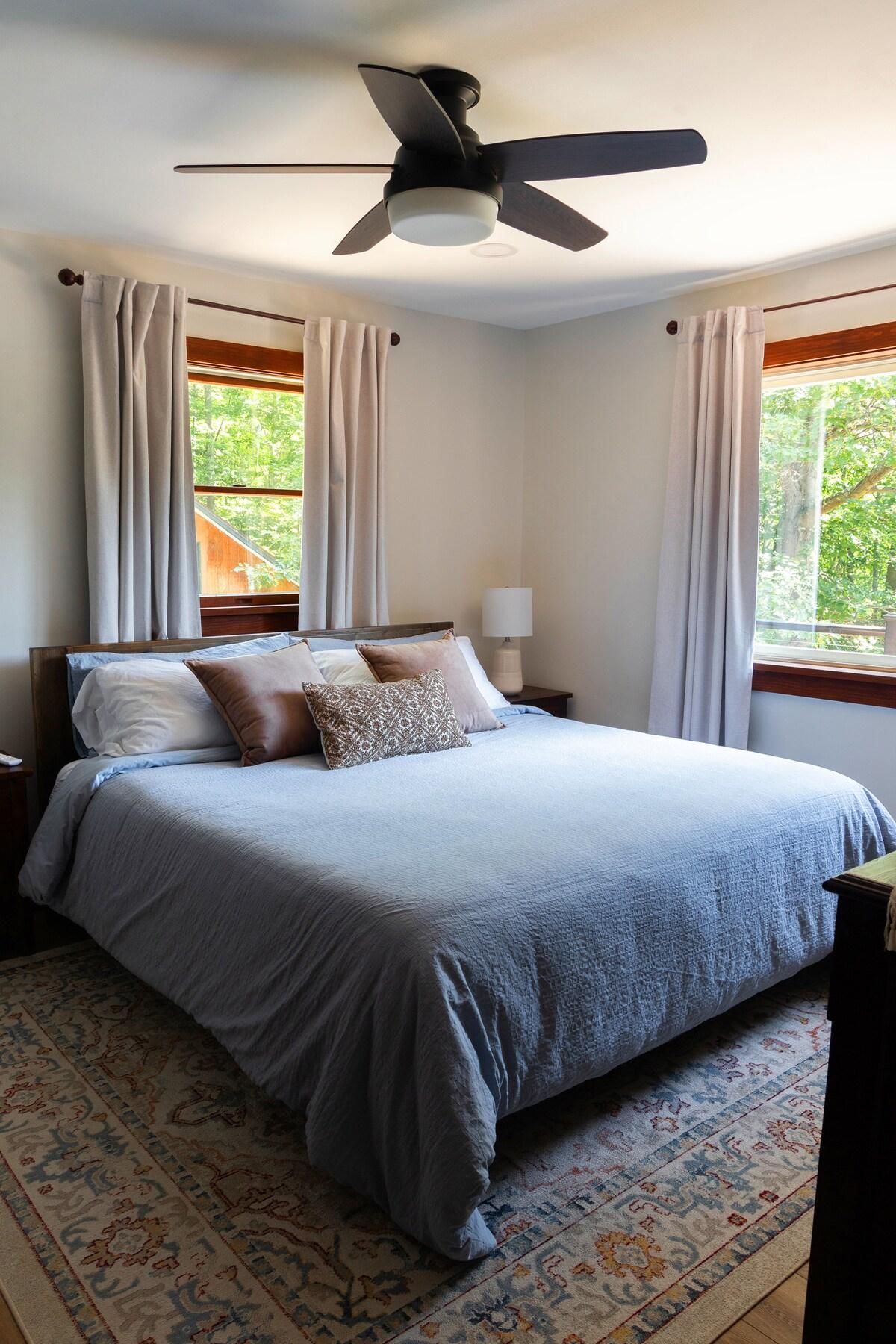 Sink into the king bed knowing the room stays exactly as cool as you want it — mini-split, blackout curtains, no excuses for a short sleep.