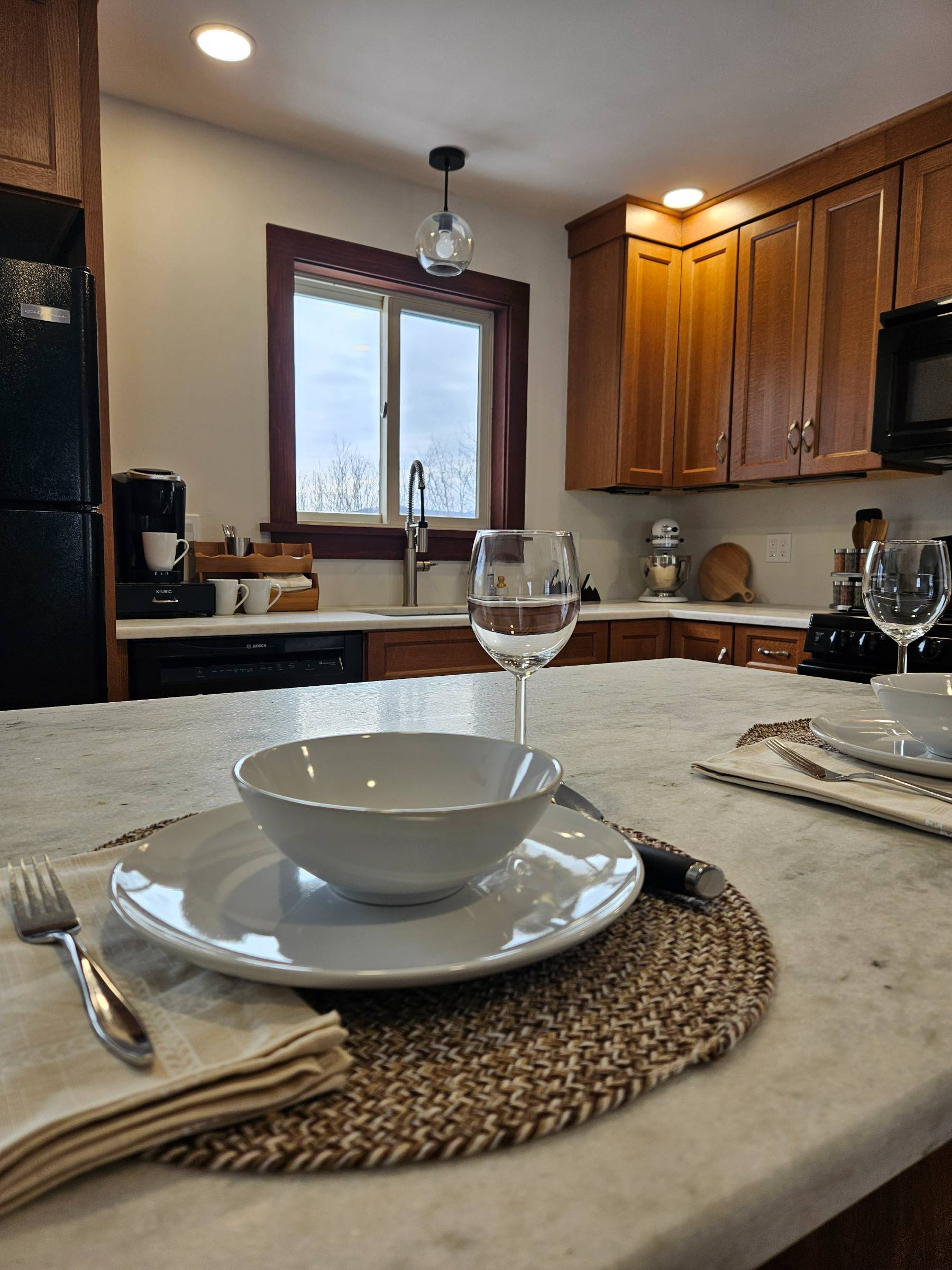 Set the island for dinner and eat together without anyone feeling squeezed — there's room for everyone and the mountain view comes with it.