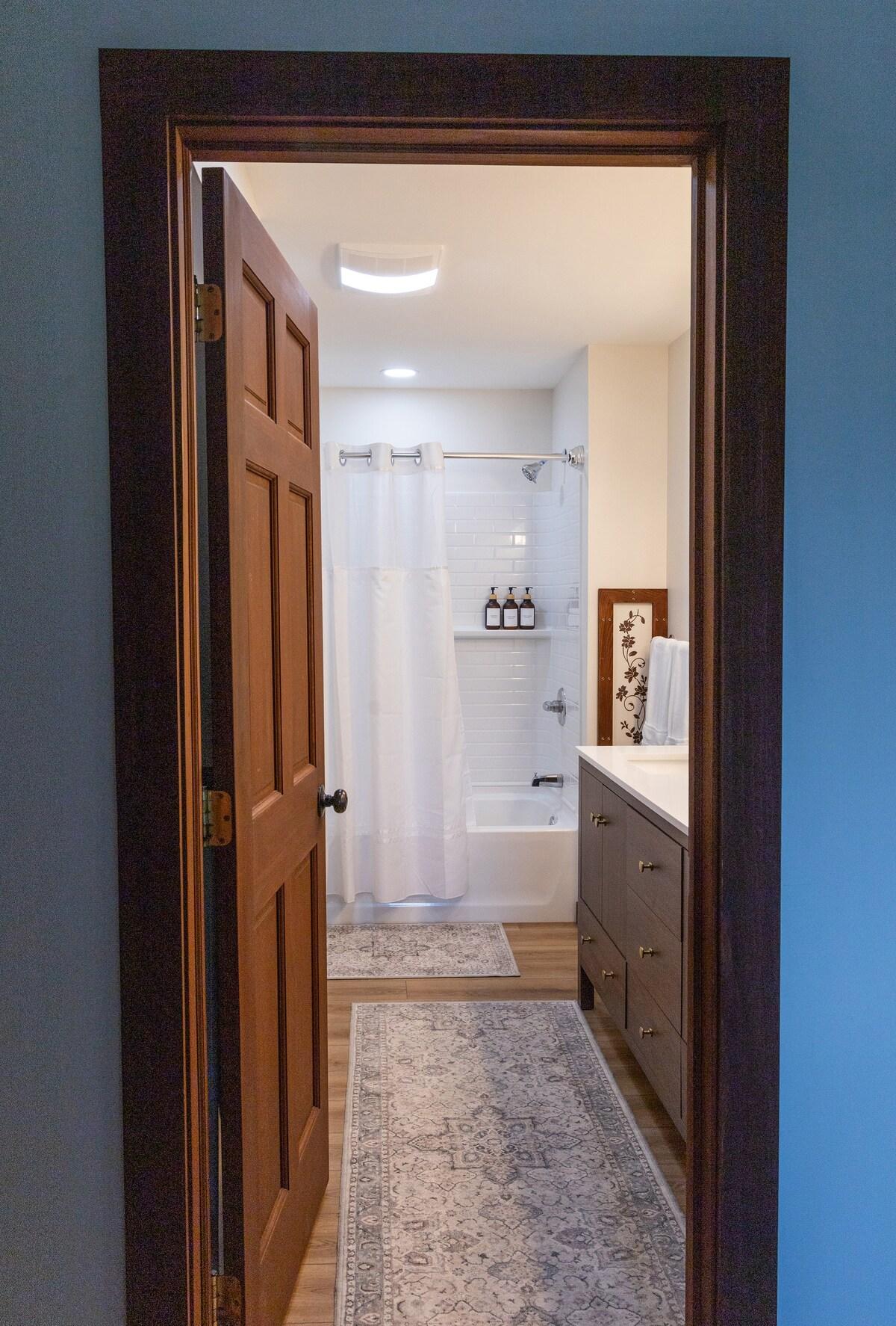 The main bathroom feature marble counter, double sinks, and a bathtub/shower for the family.