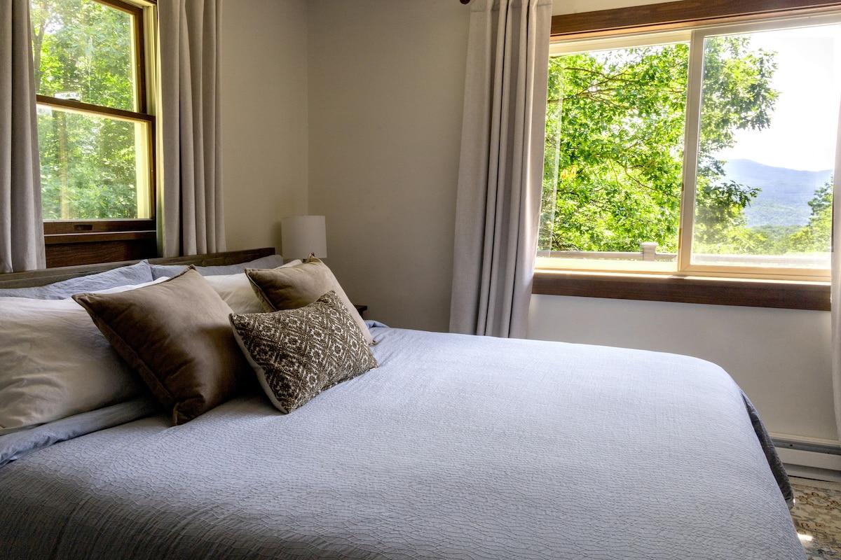 Wake up to the mountains before you've even made coffee — the window does all the work.